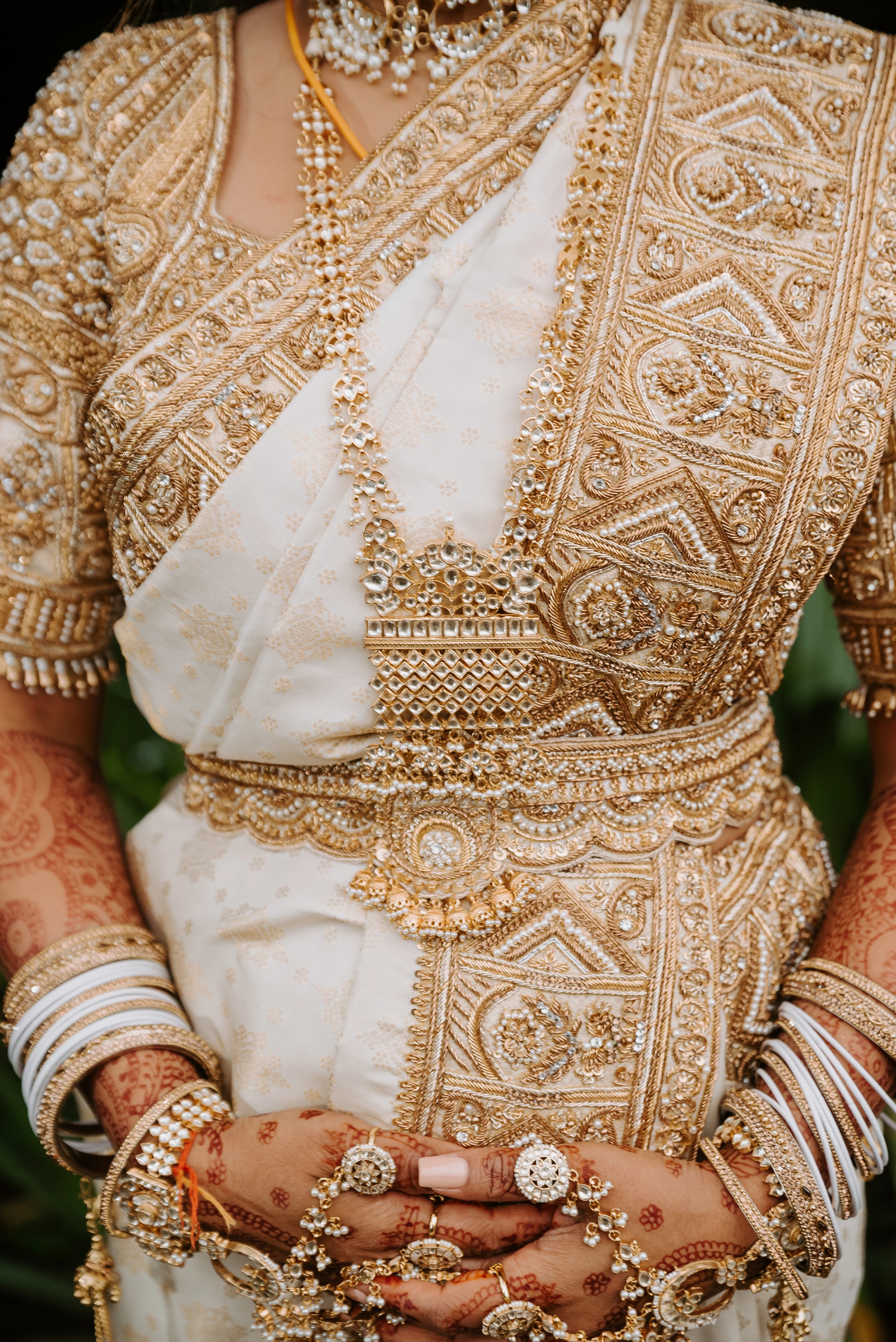 Bride Shayal showcasing detailings in an ivory silk concept blouse & saree border, intricately handcrafted with zardozi, stones, pearls and coins by team Archana Karthick.
