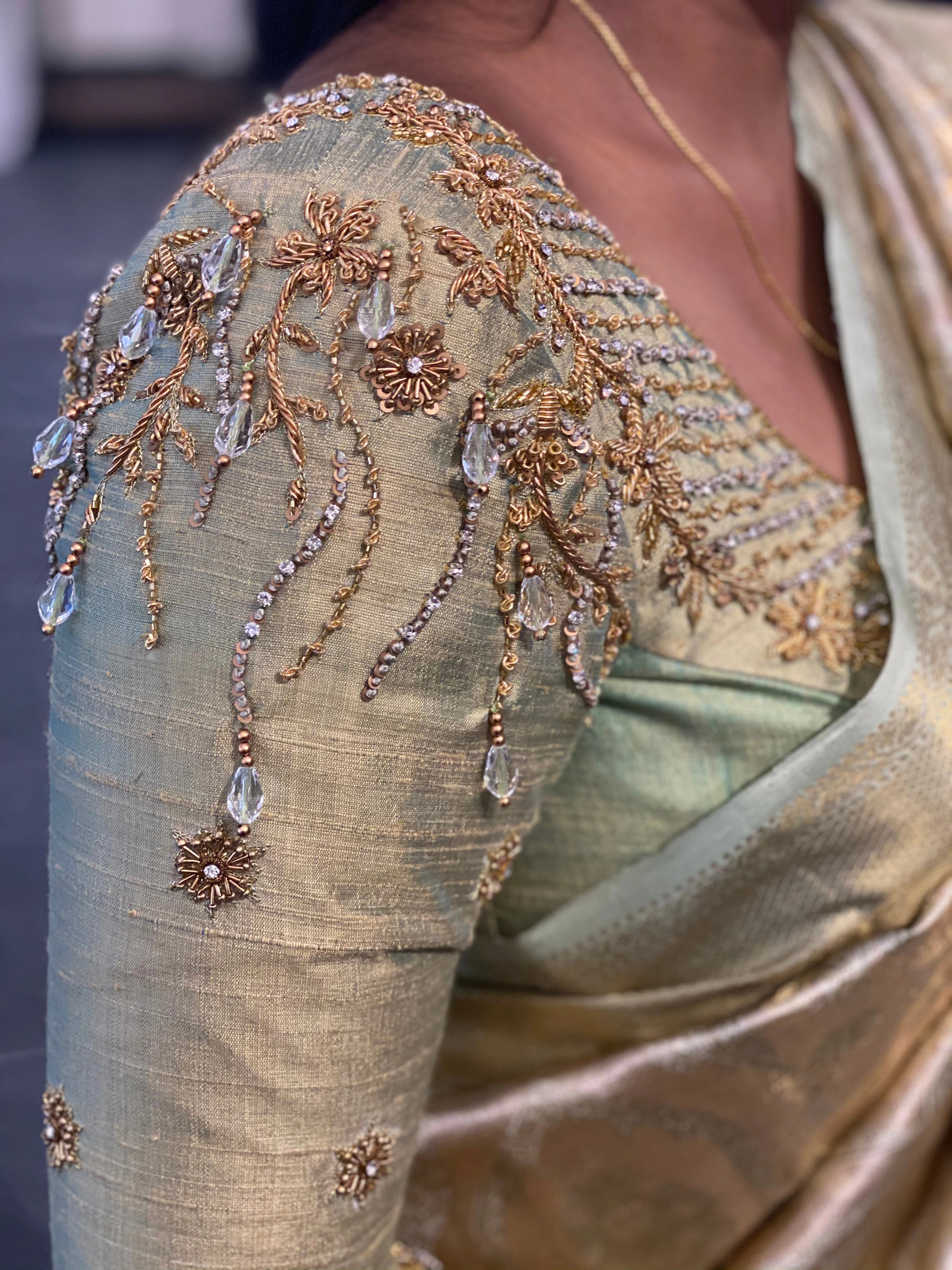Bride Sherin during fittings in an olive green silk blouse, handcrafted by team Archana Karthick.