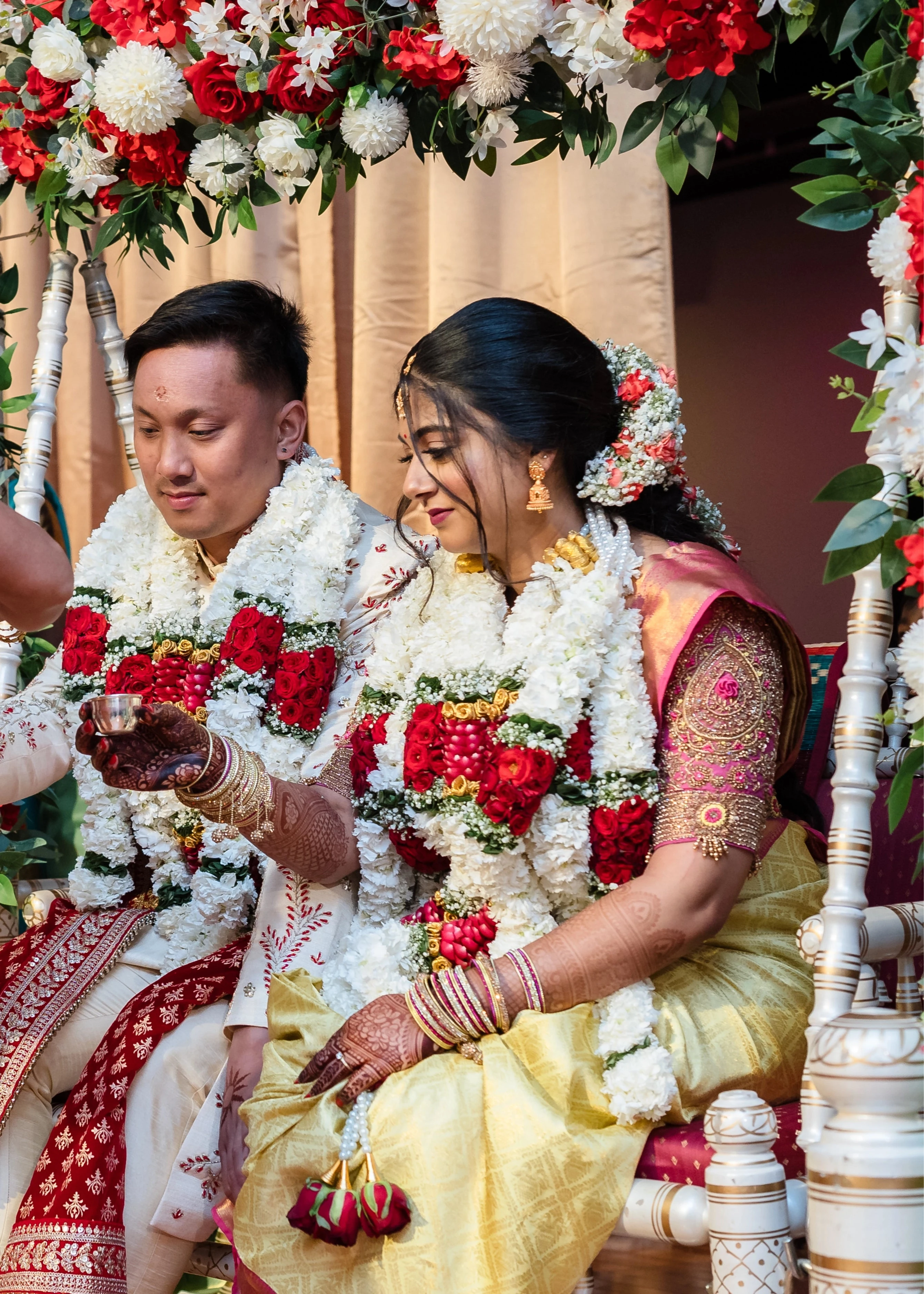 Bride Shivani during ritual in a pink silk blouse & belt, intricately handcrafted with beads, stones, resham, sequins and zardozi by team Archana Karthick.