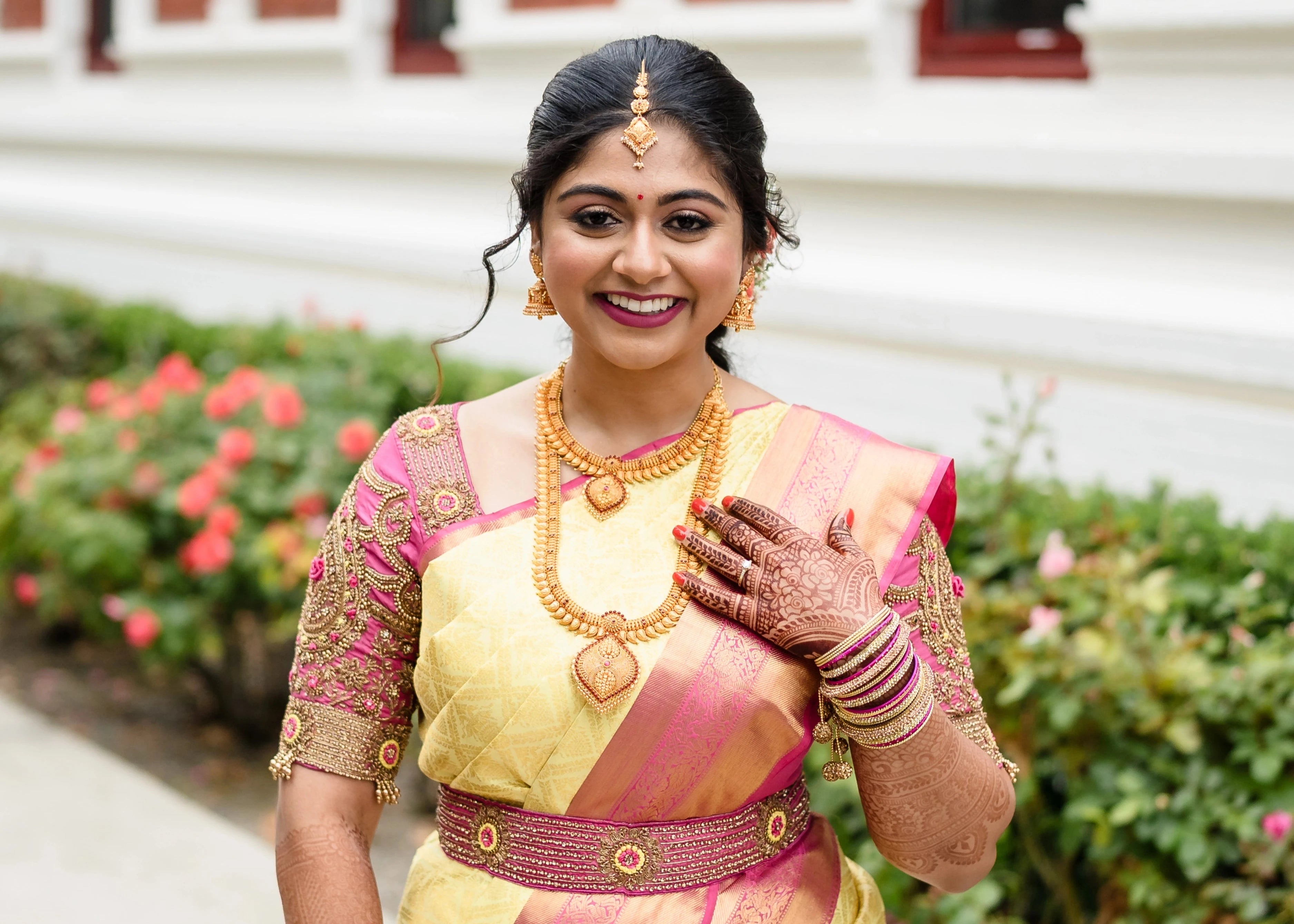 Bride Shivani in a pink silk blouse & belt, intricately handcrafted with beads, stones, resham, sequins and zardozi by team Archana Karthick.