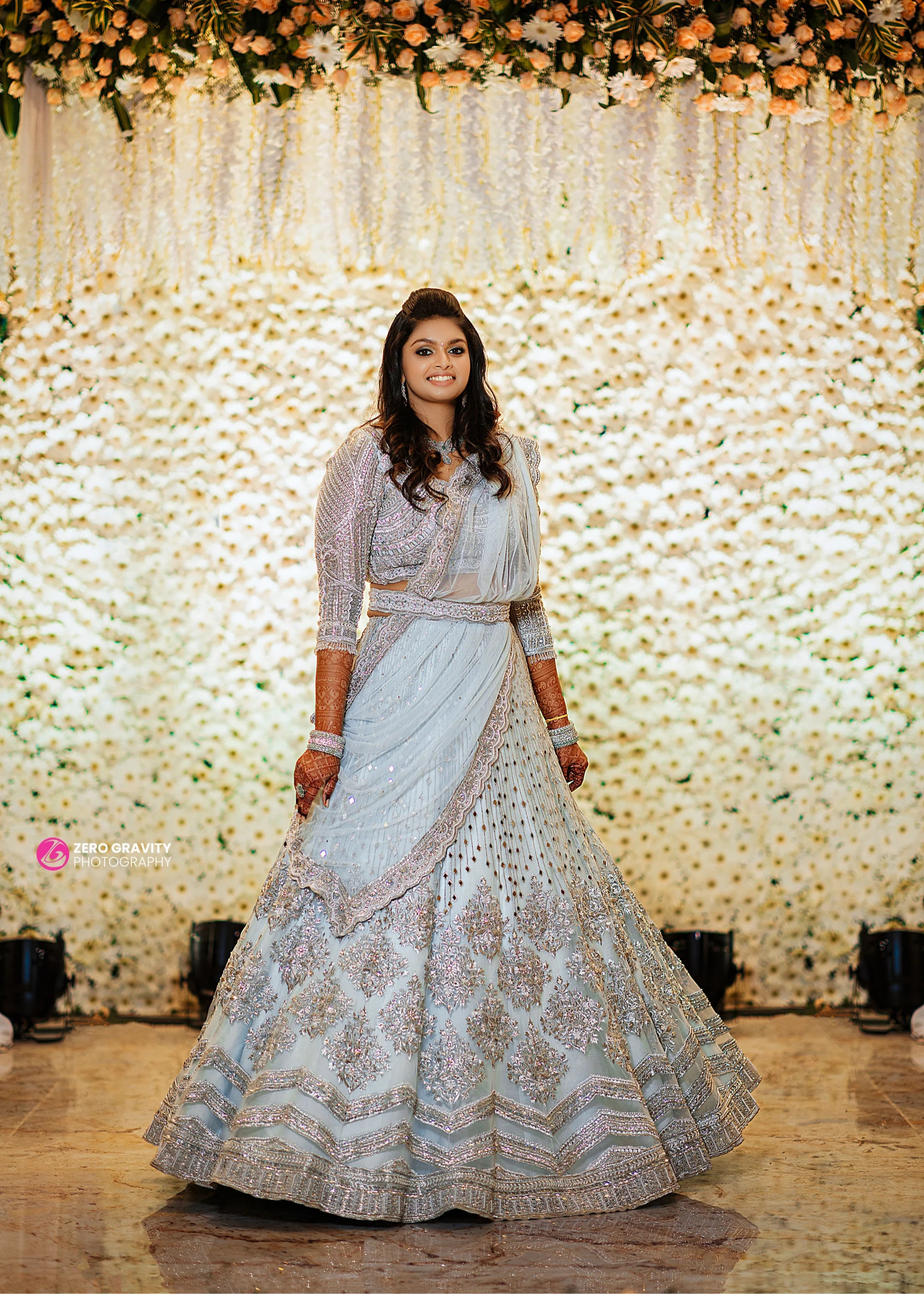 Bride Shreya from USA in a handcrafted powder blue net lehenga embellished with mirrors, pearls, zardozi, and crystals.
