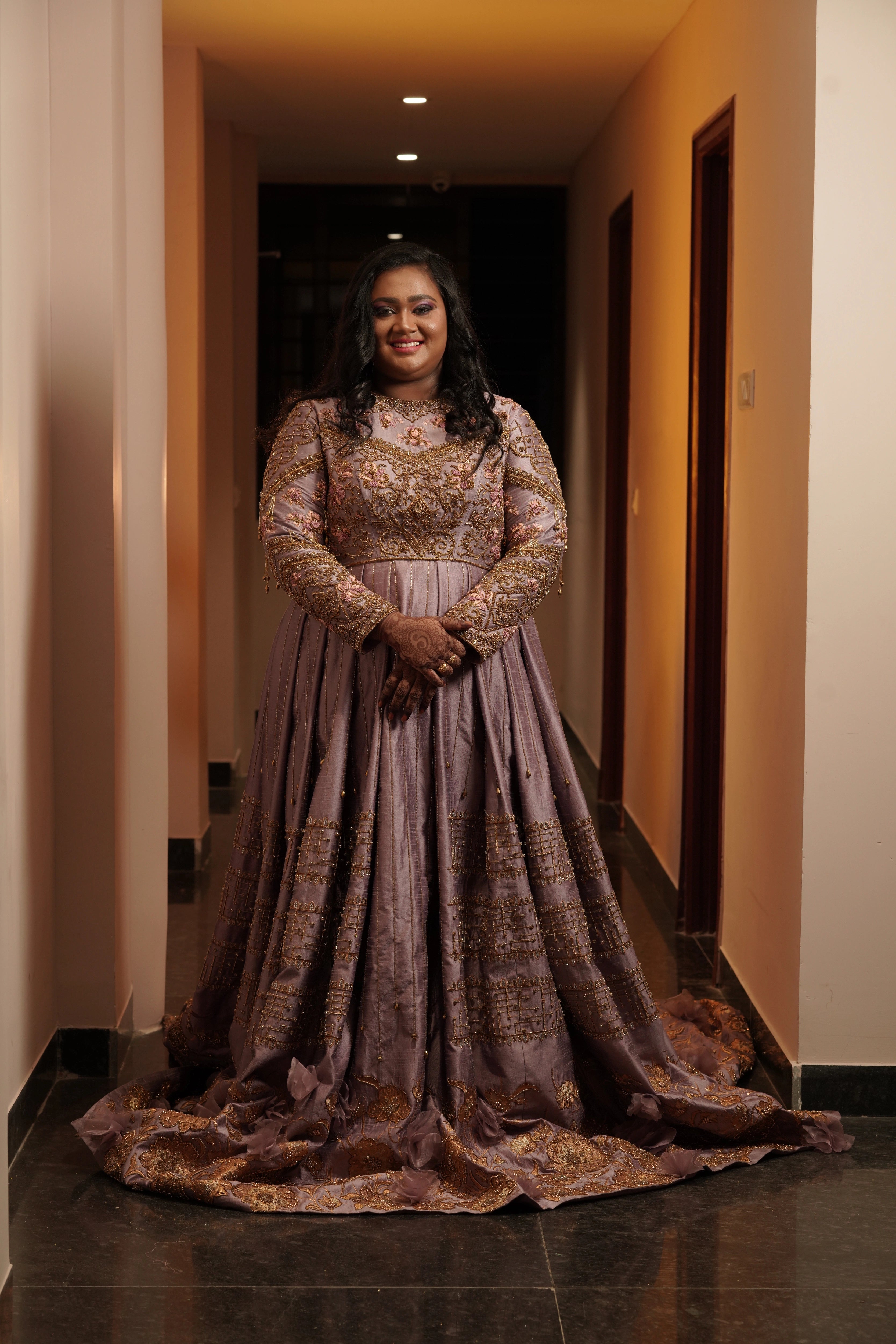 Bride Shyamaladevi in a dusty mauve raw silk gown, intricately handcrafted with beads, cutdana, stones, resham and zardozi by team Archana Karthick.