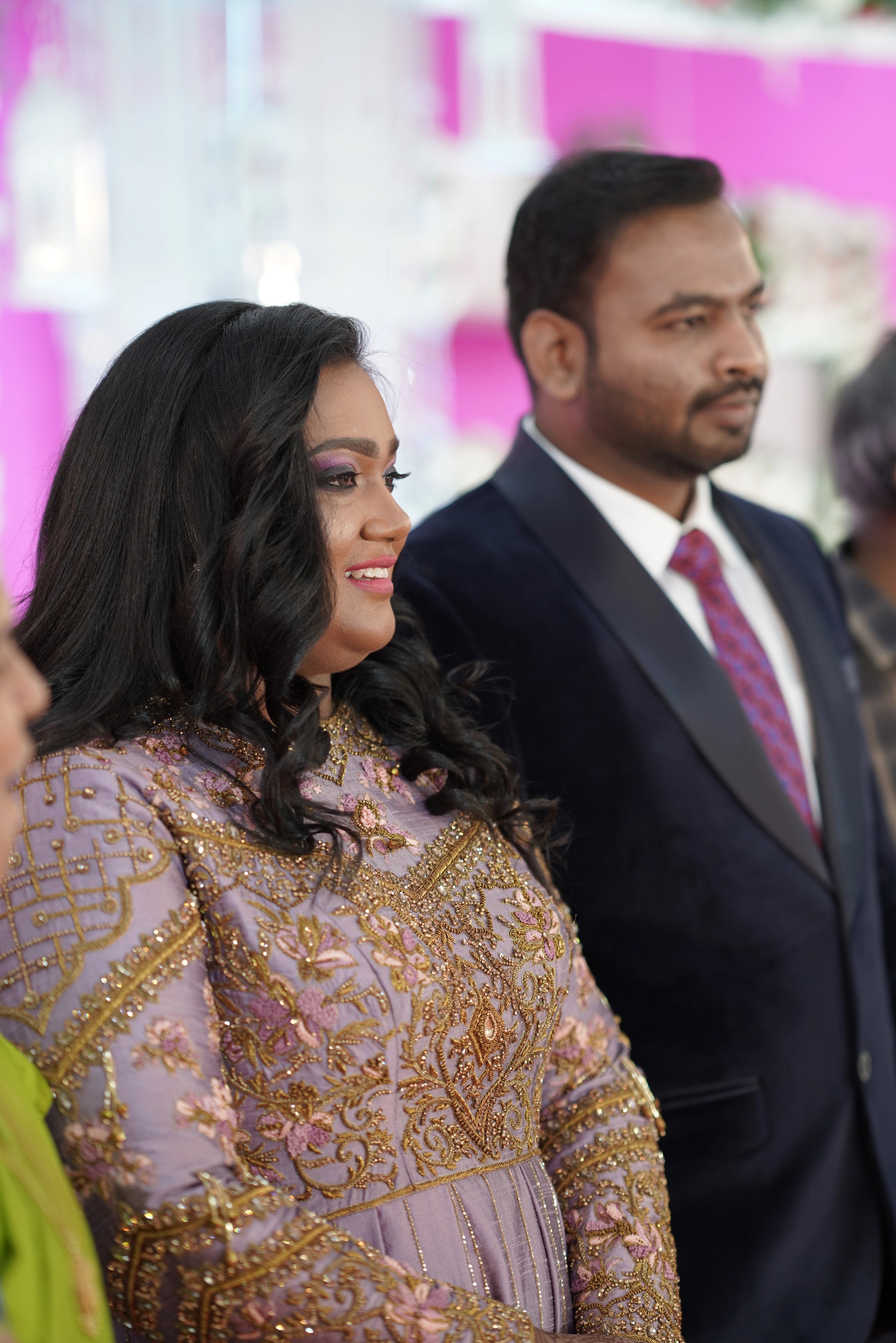 Bride Shyamaladevi posing with groom in a dusty mauve raw silk gown, intricately handcrafted with beads, cutdana, stones, resham and zardozi by team Archana Karthick.