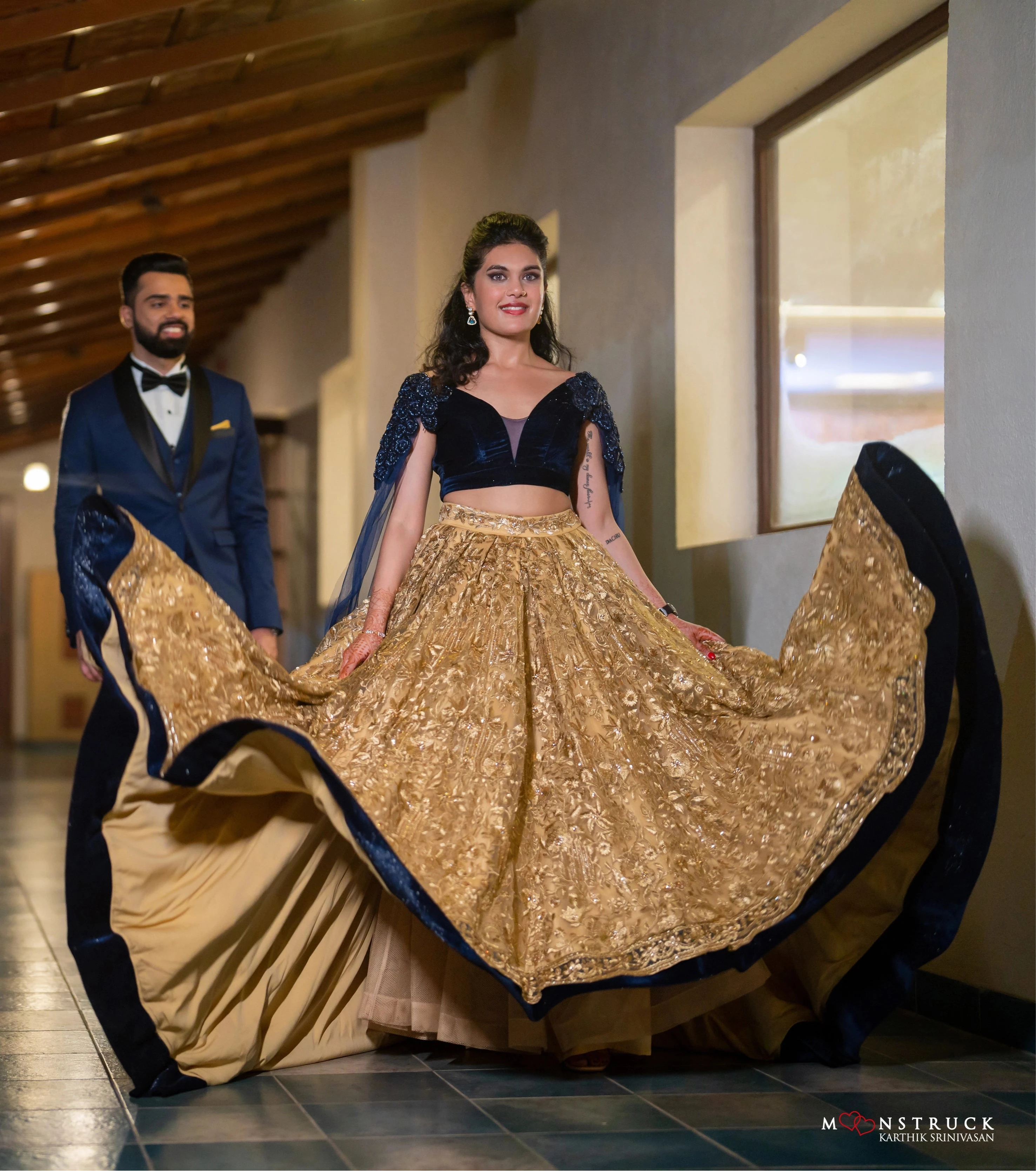 Bride Sneha Murugan in a midnight blue (velvet) and gold (tulle) lehenga, intricately handcrafted with zari, sequins, cutdana and stones by team Archana Karthick.
