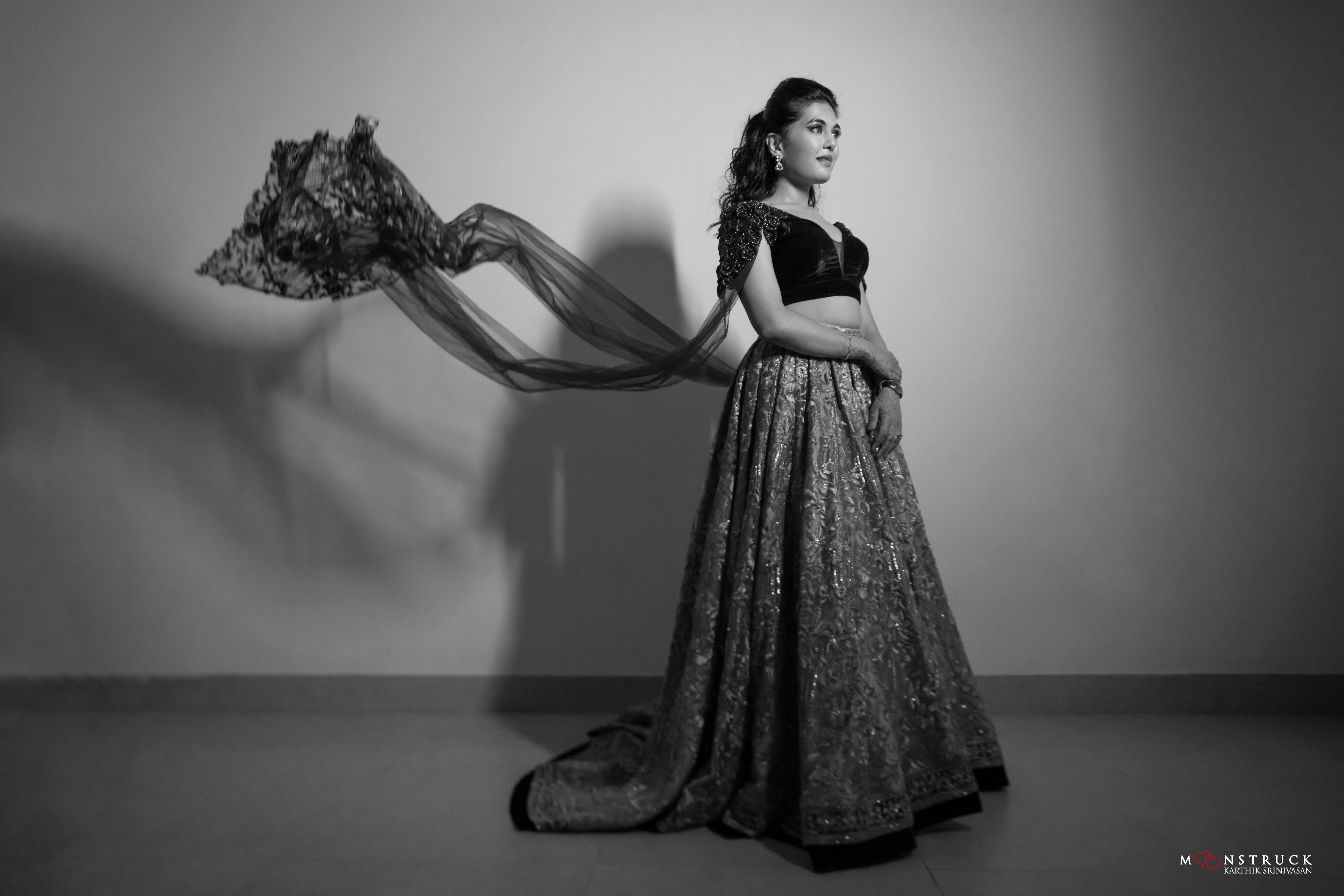 Bride Sneha Murugan in a photoshoot in a midnight blue (velvet) and gold (tulle) lehenga, intricately handcrafted with zari, sequins, cutdana and stones by team Archana Karthick.