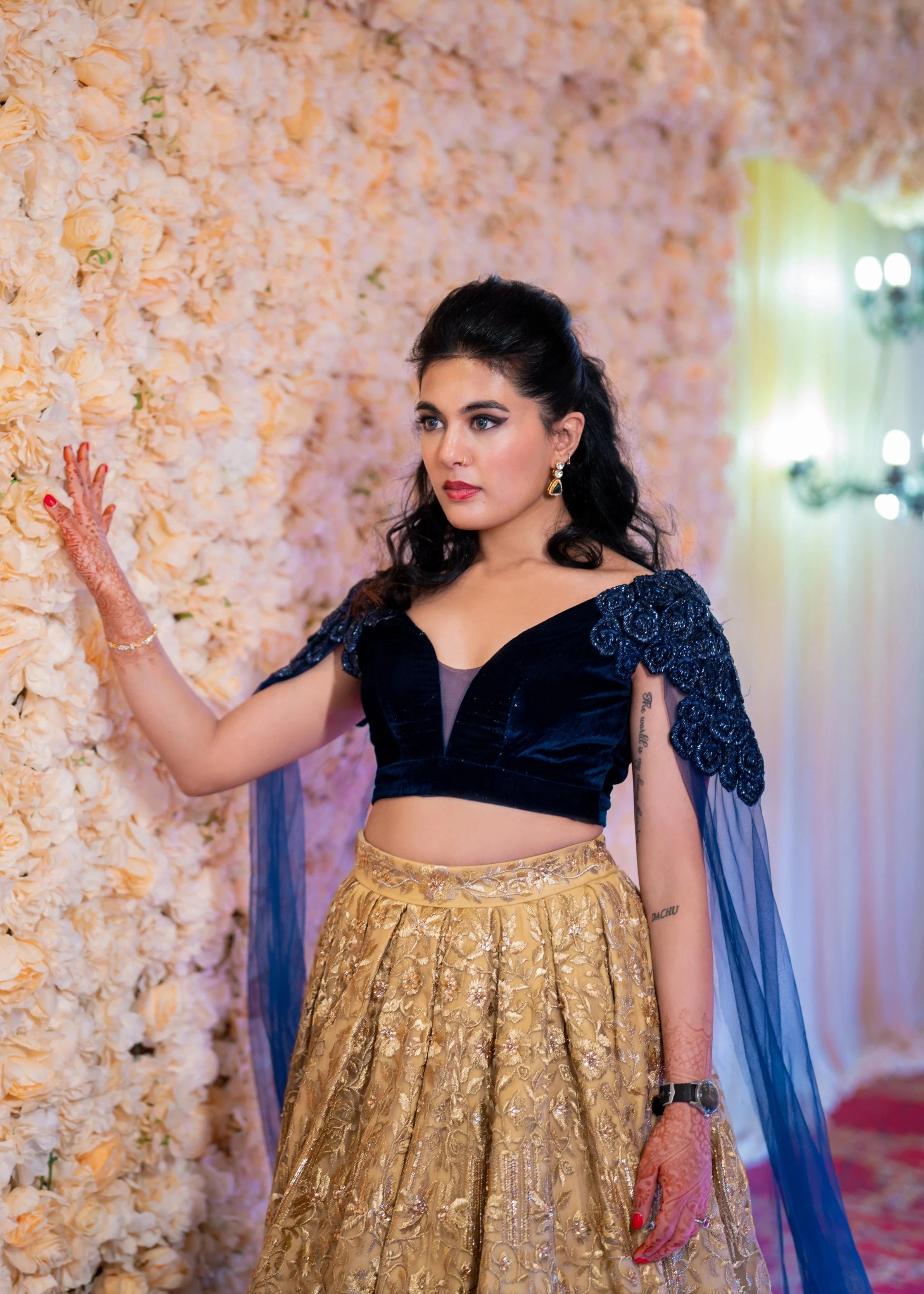 Bride Sneha Murugan posing in a midnight blue (velvet) and gold (tulle) lehenga, intricately handcrafted with zari, sequins, cutdana and stones by team Archana Karthick.