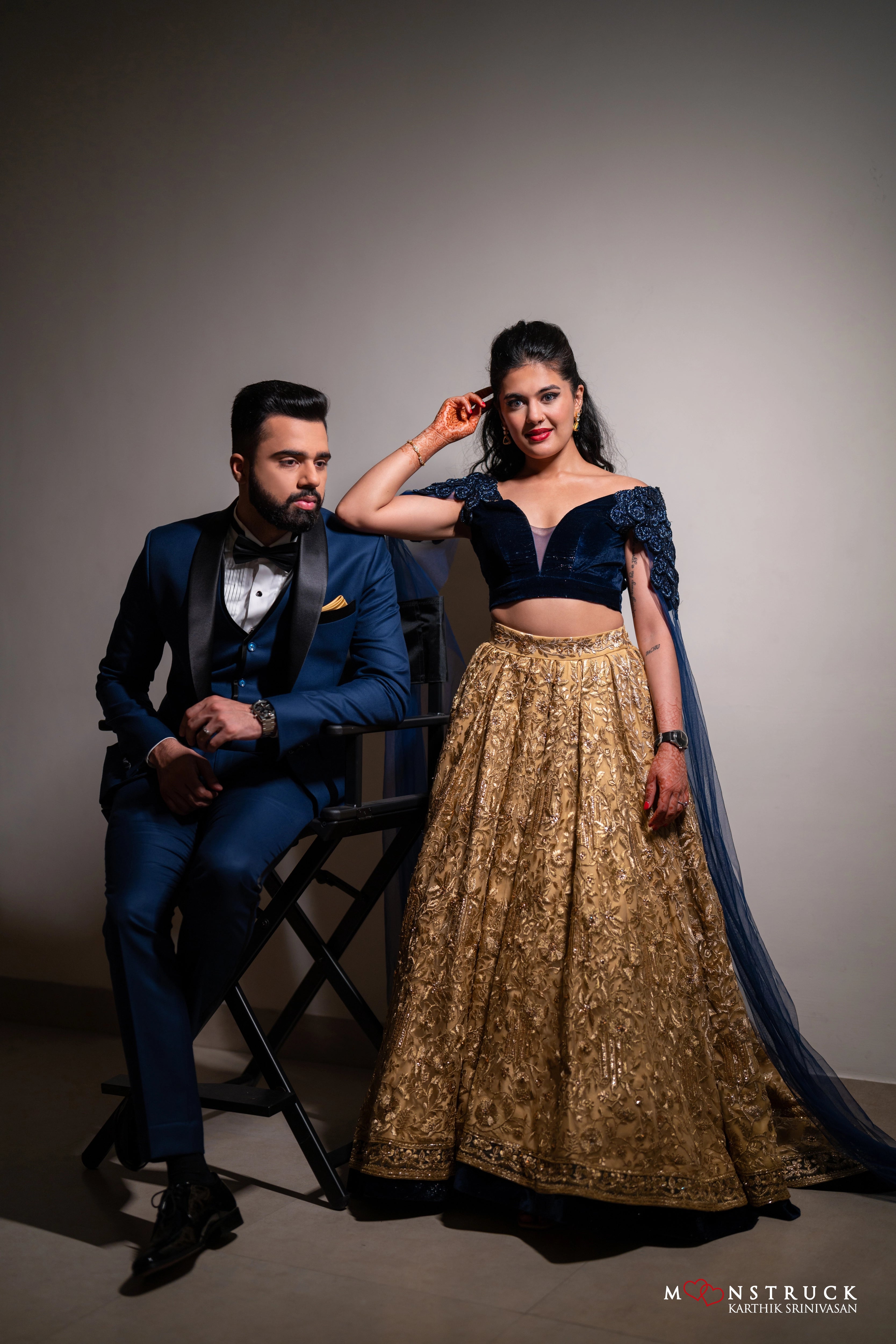 Bride Sneha Murugan with groom in a midnight blue (velvet) and gold (tulle) lehenga, intricately handcrafted with zari, sequins, cutdana and stones by team Archana Karthick.