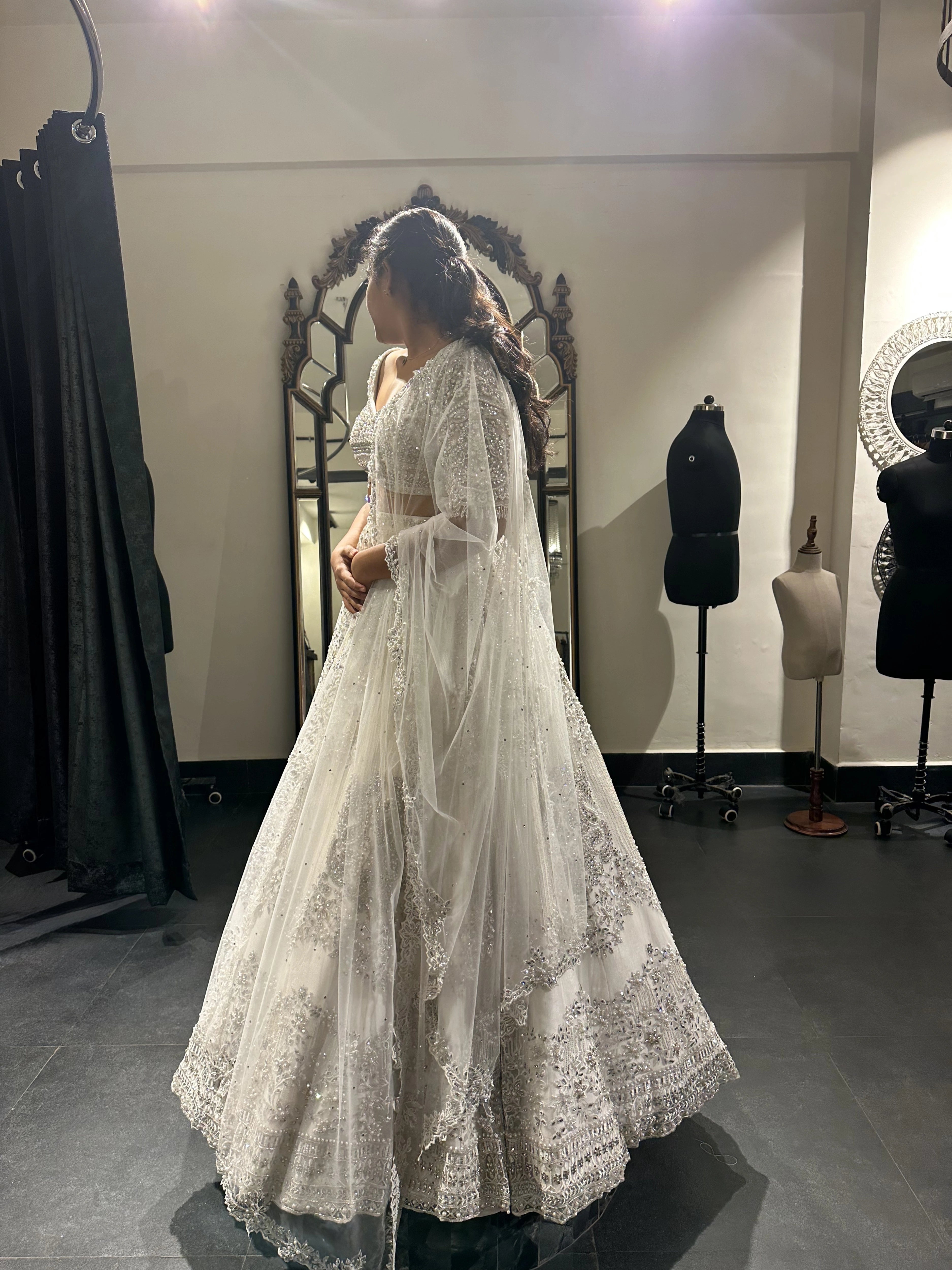 Bride Sneha from Chennai in a silver raw silk lehenga, intricately handcrafted with zari, cutdana, zardozi, crystals and stones by team Archana Karthick.