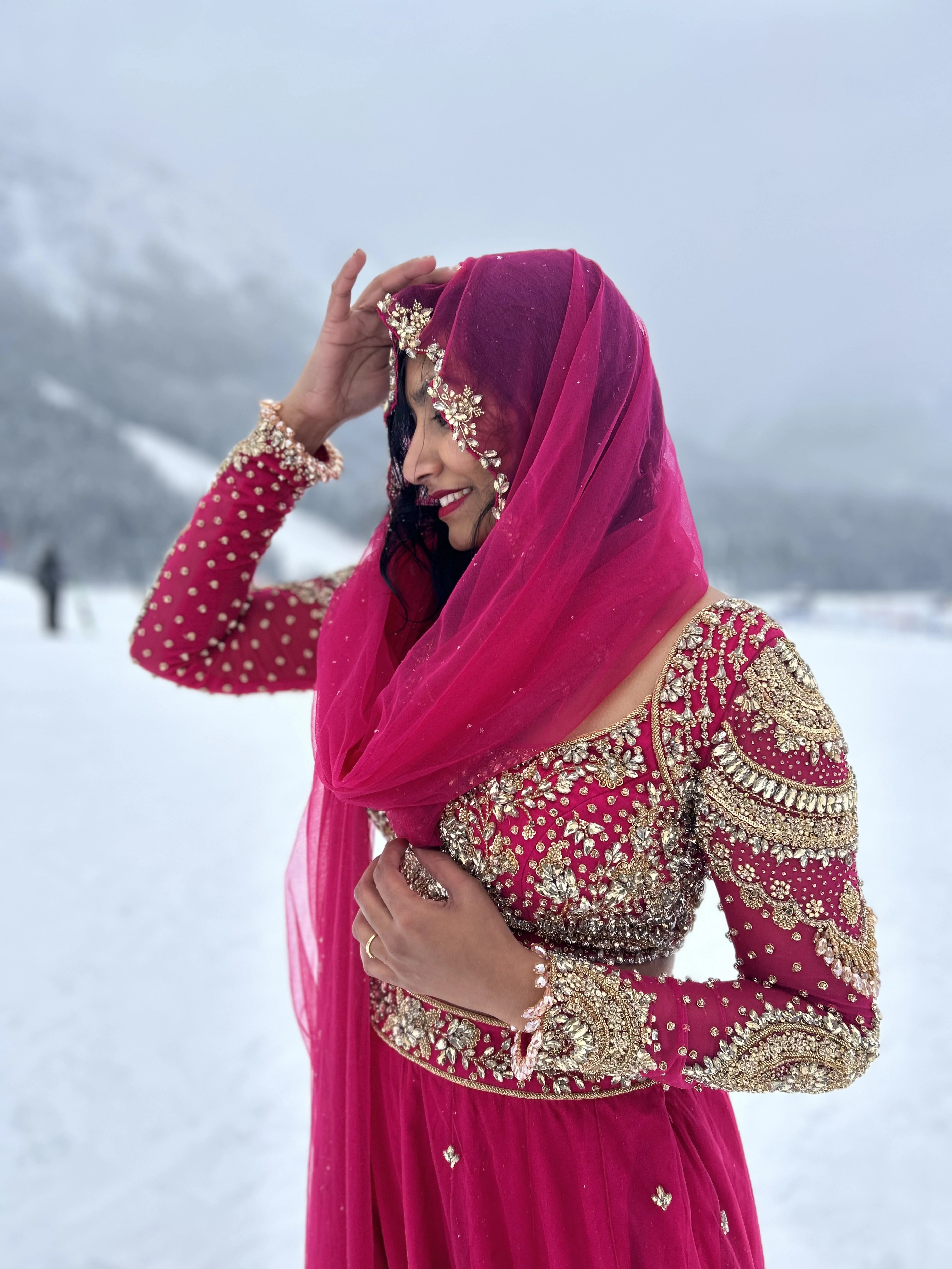 Bride Steffy from Italy, posing in a pink tulle reception lehenga by team Archana Karthick.