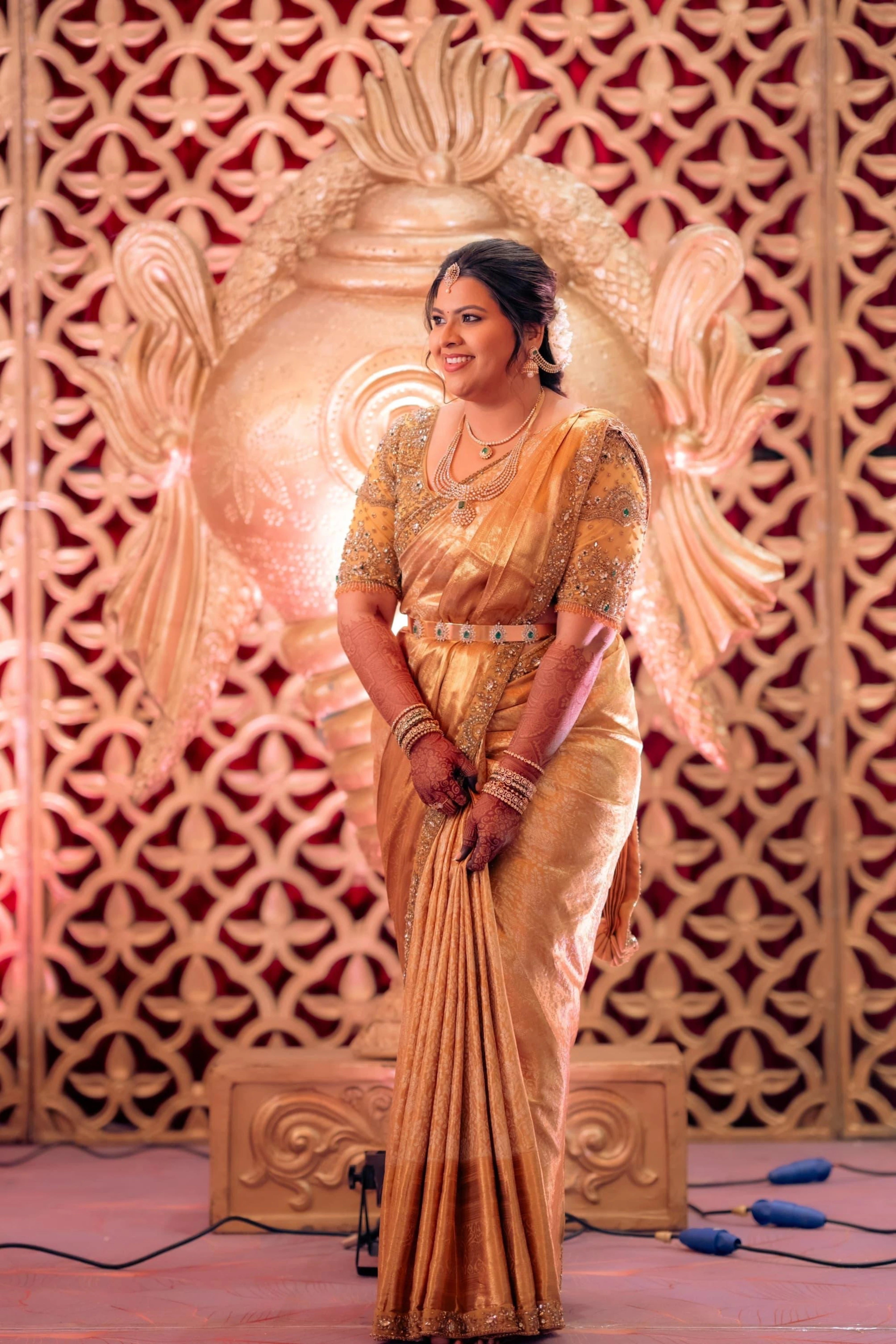 Bride Surrekha in a gold silk blouse and saree border by team Archana Karthick.
