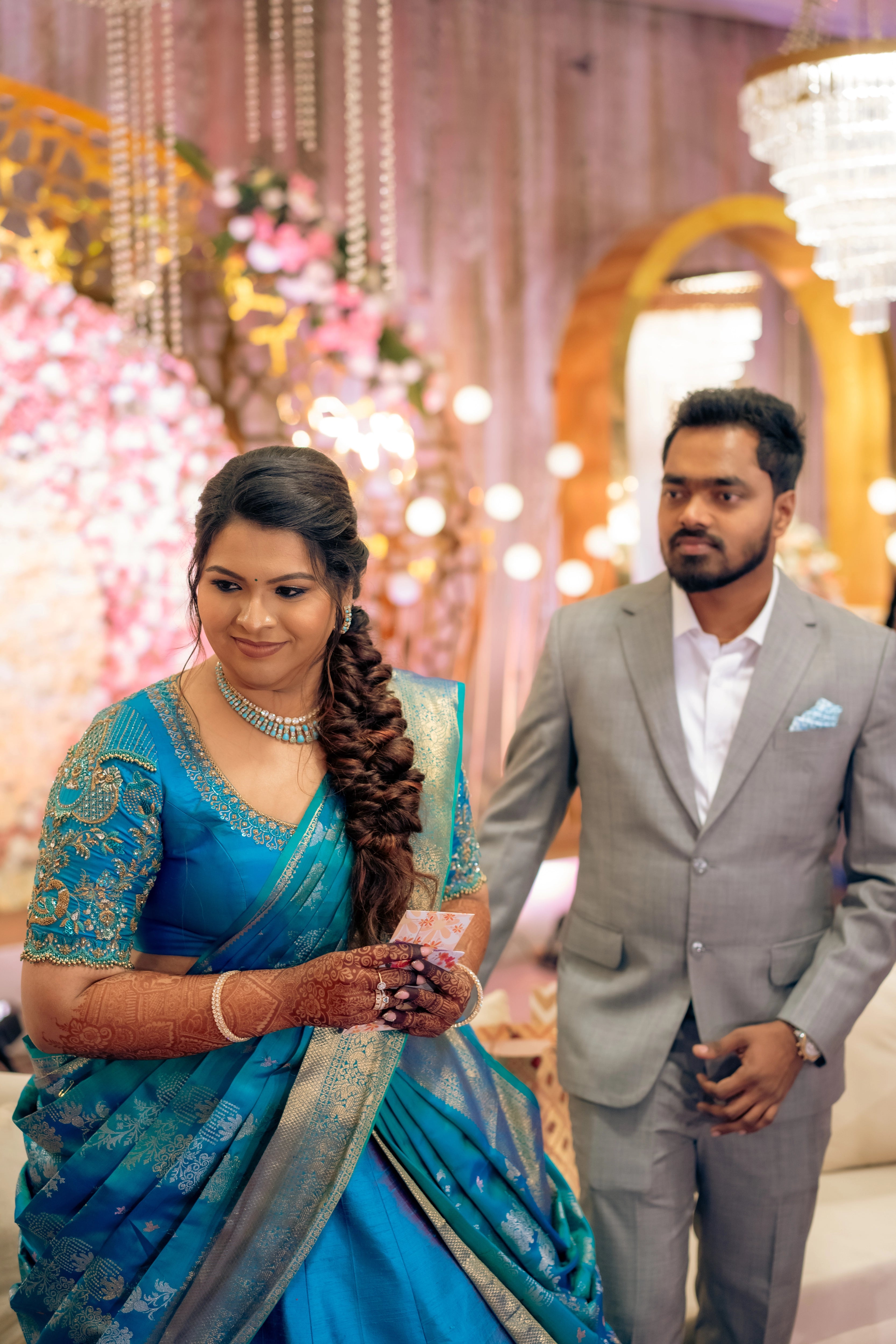 Bride Surrekha posing in a blue silk half saree by Archana Karthick