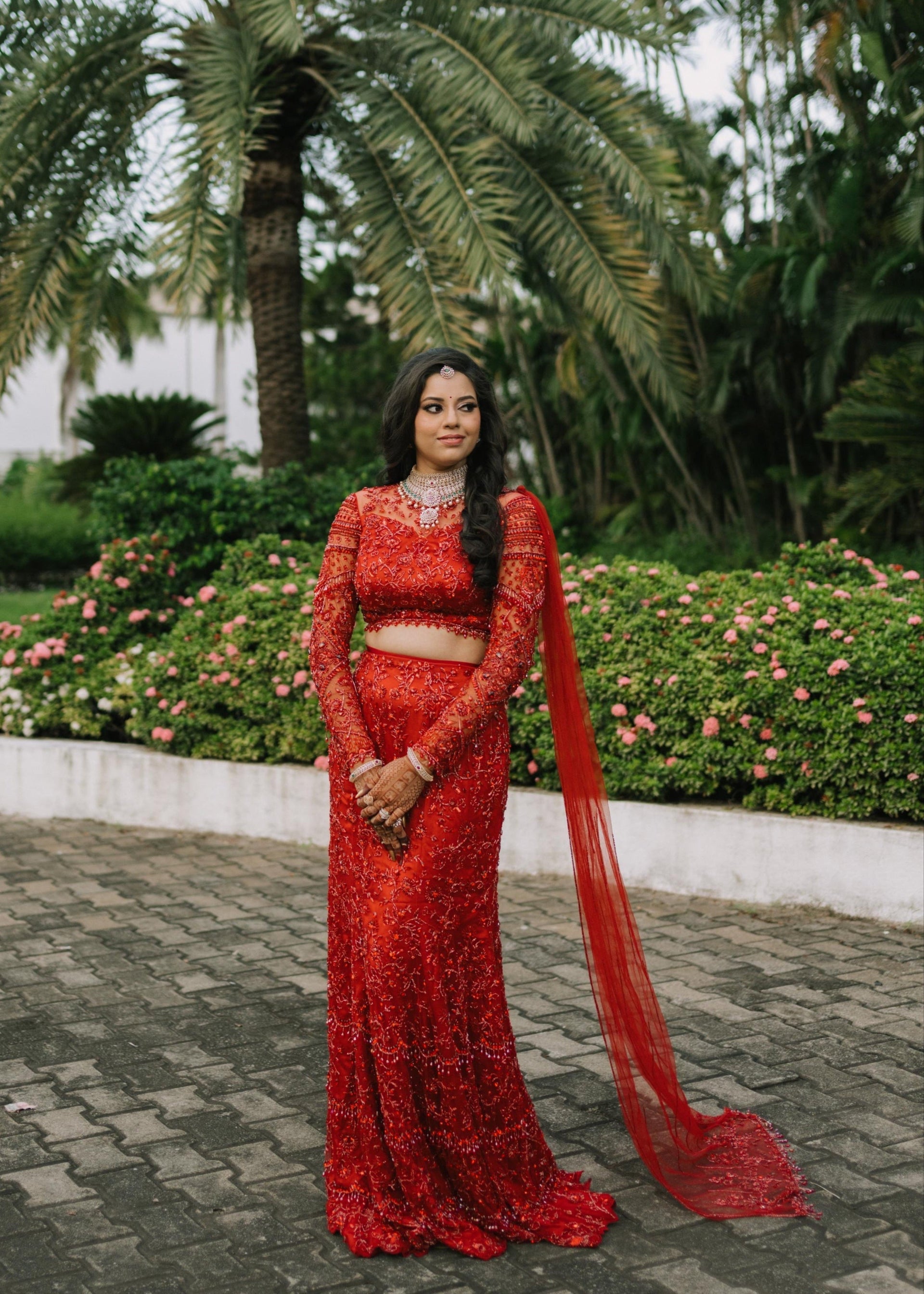 Bride Urmila for her reception in a red handcrafted mermaid lehenga drape designed by Archana Karthick.