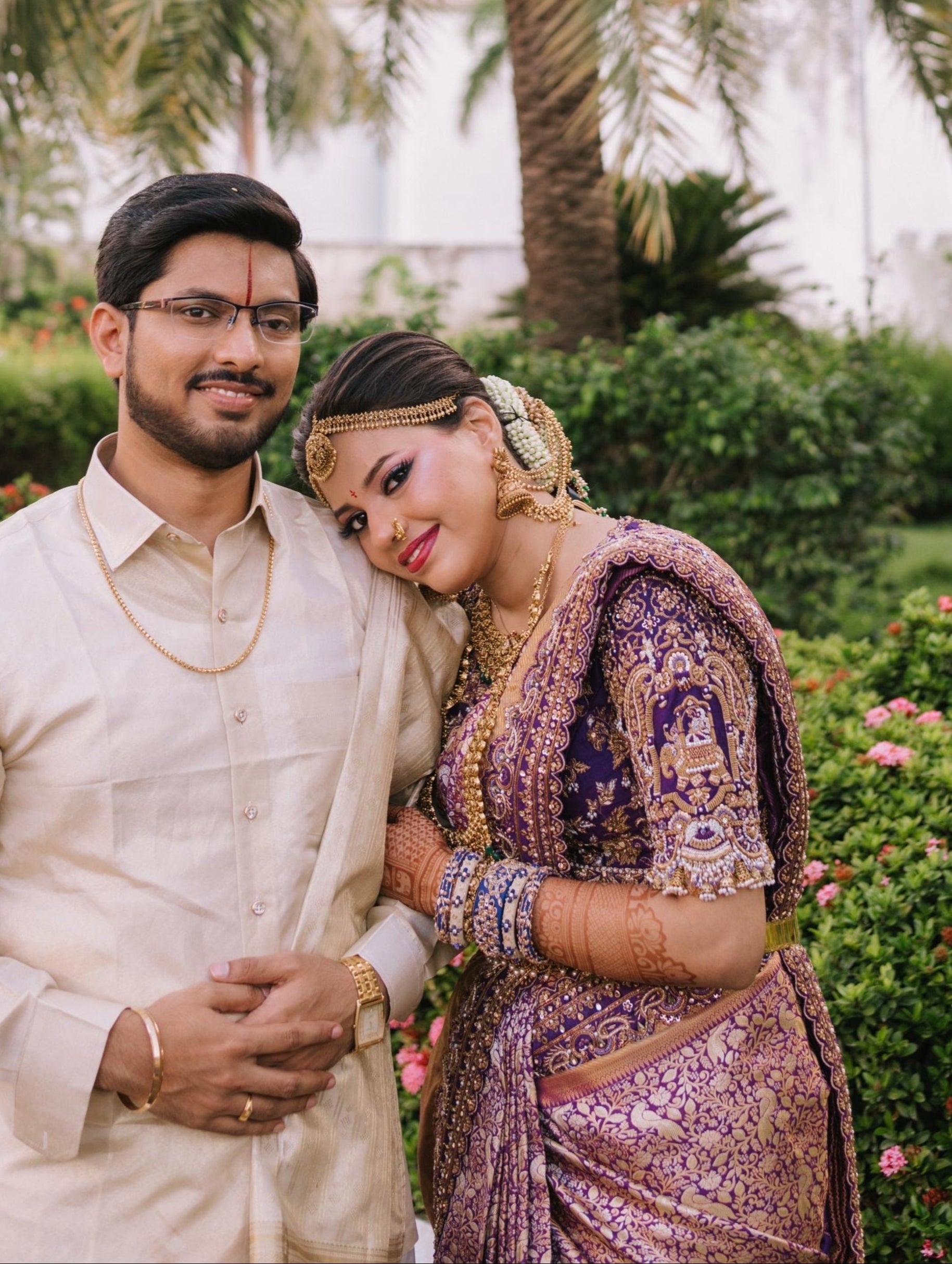 Bride Urmila posing elegantly in a closeup shot of her handcrafted blouse and saree border for her wedding muhurtham designed by Archana Karthick. Posing with groom.