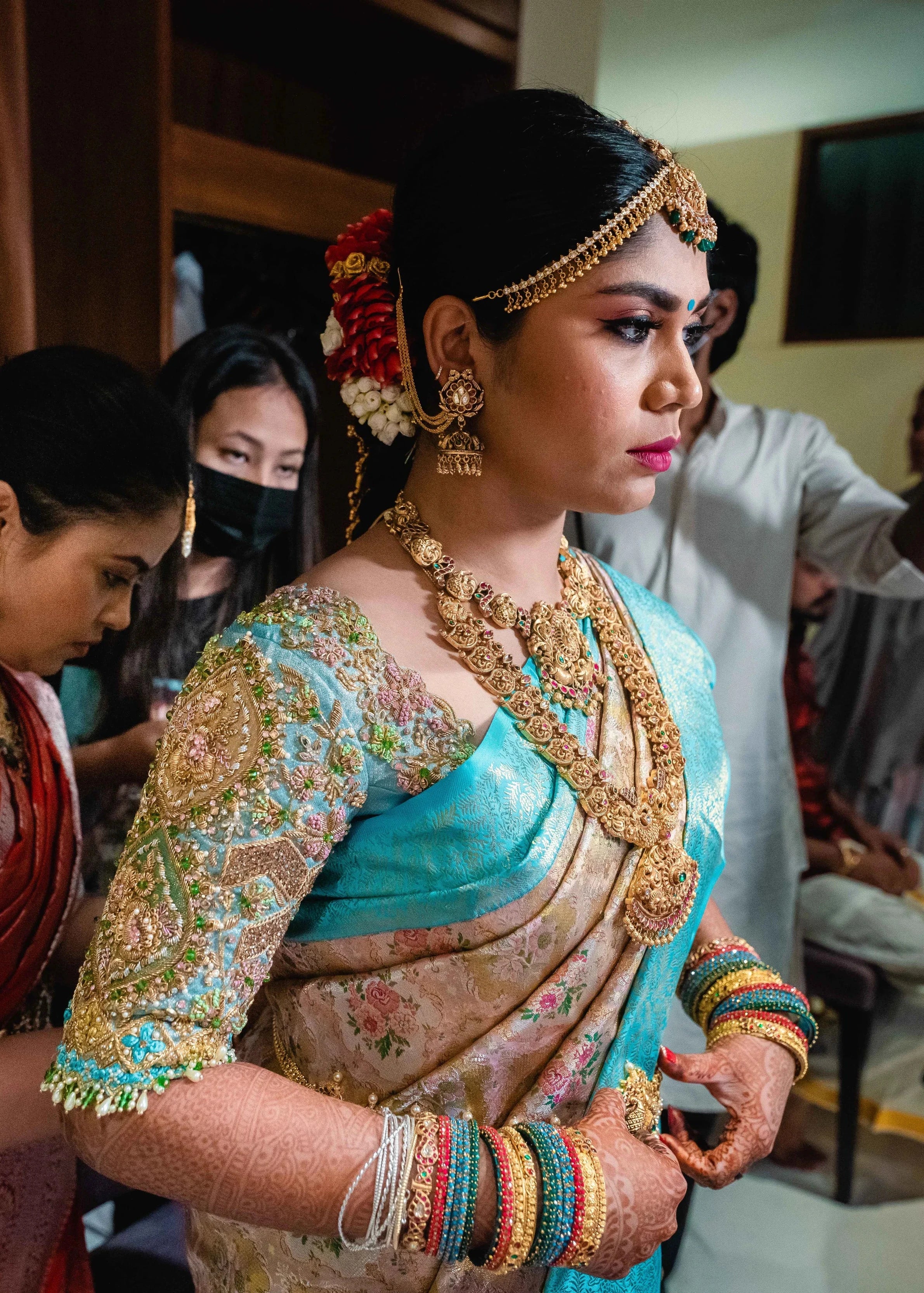 Bride Vidya D posing in a powder blue silk blouse, handcrafted with beads, zardozi, kundan, resham, stones and crystals by team Archana Karthick.
