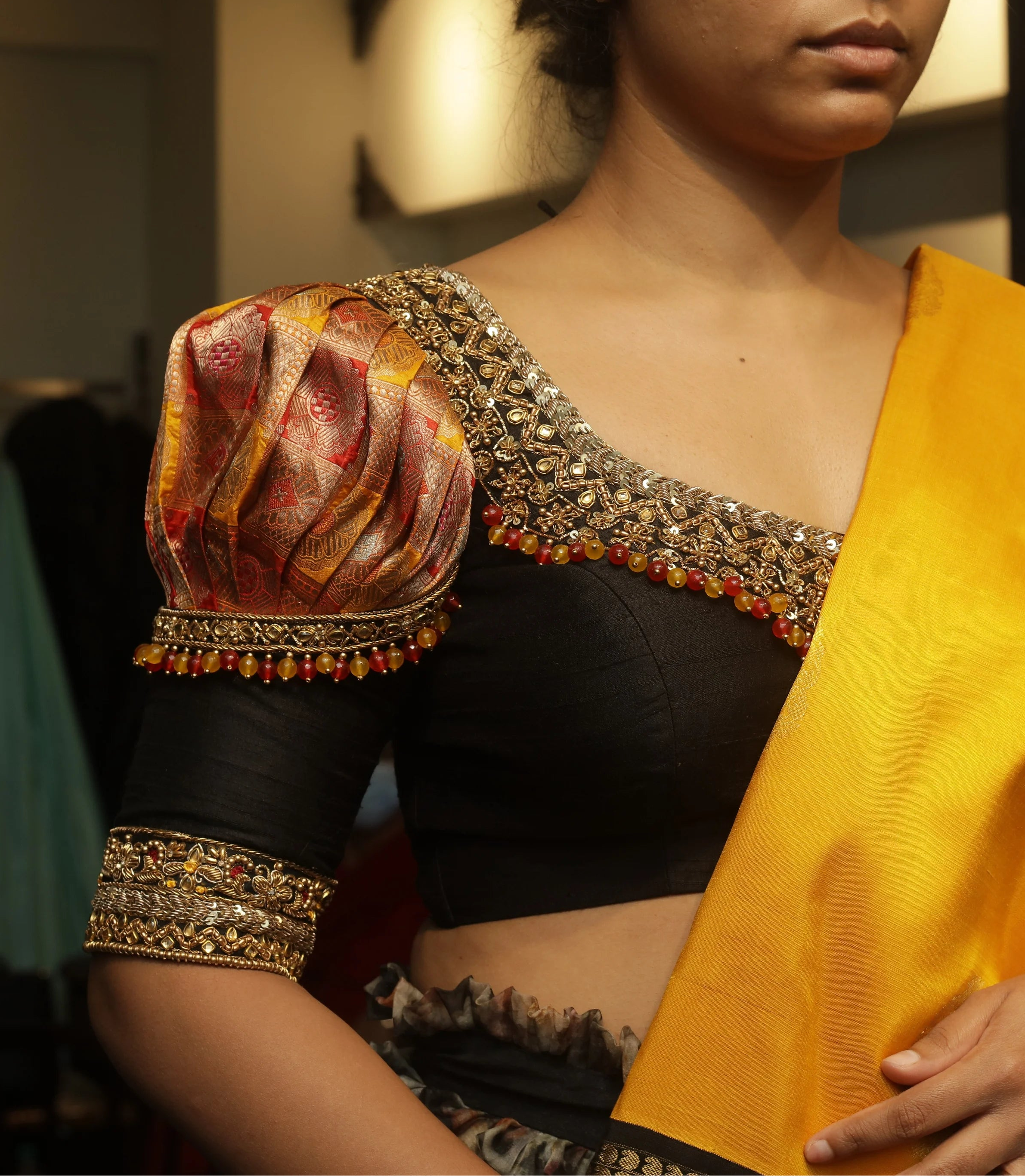 Bride Vidya during fittings in a black silk puff sleeved blouse handcrafted by team Archana Karthick.