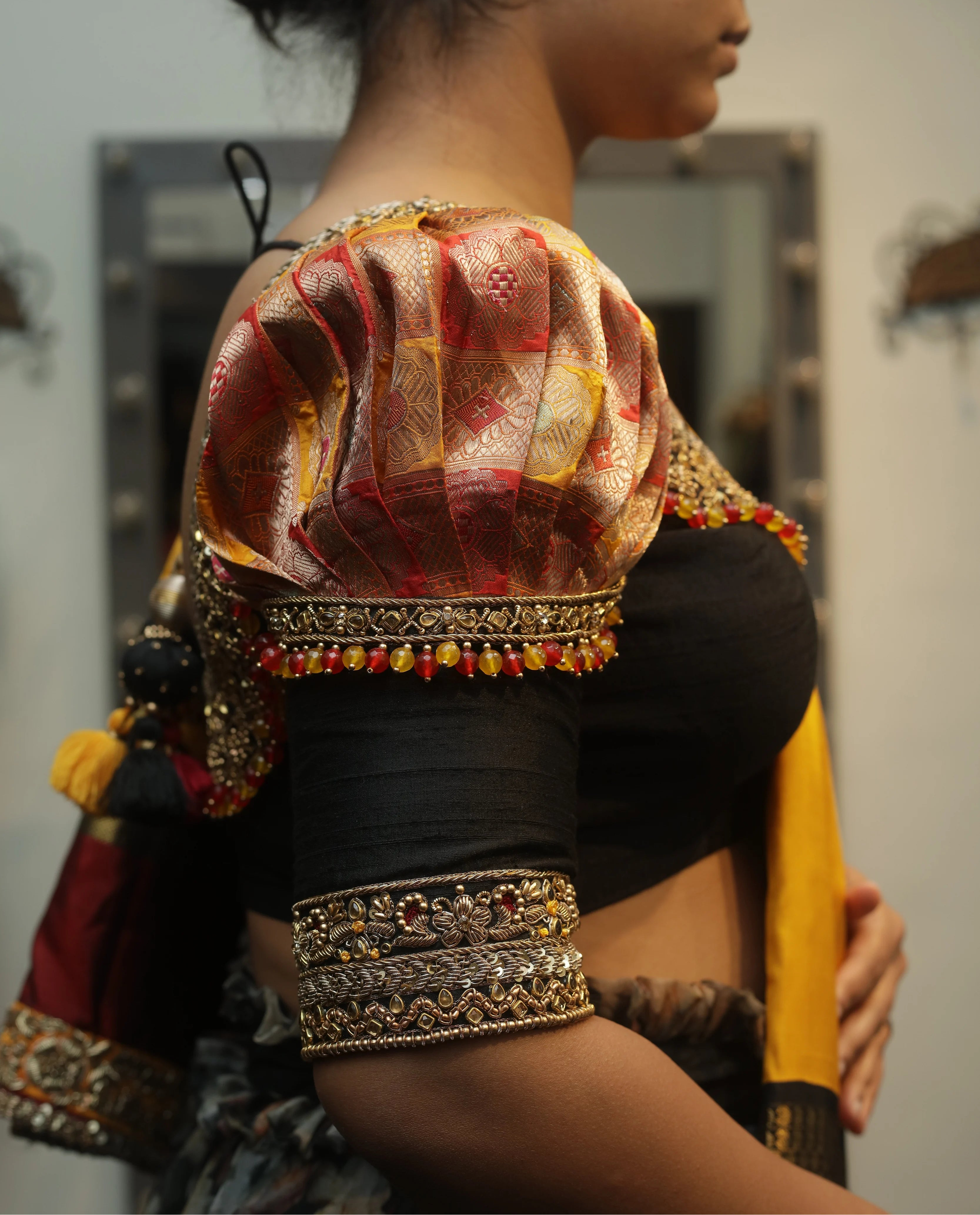 Bride Vidya in a black silk puff sleeved blouse handcrafted by team Archana Karthick.