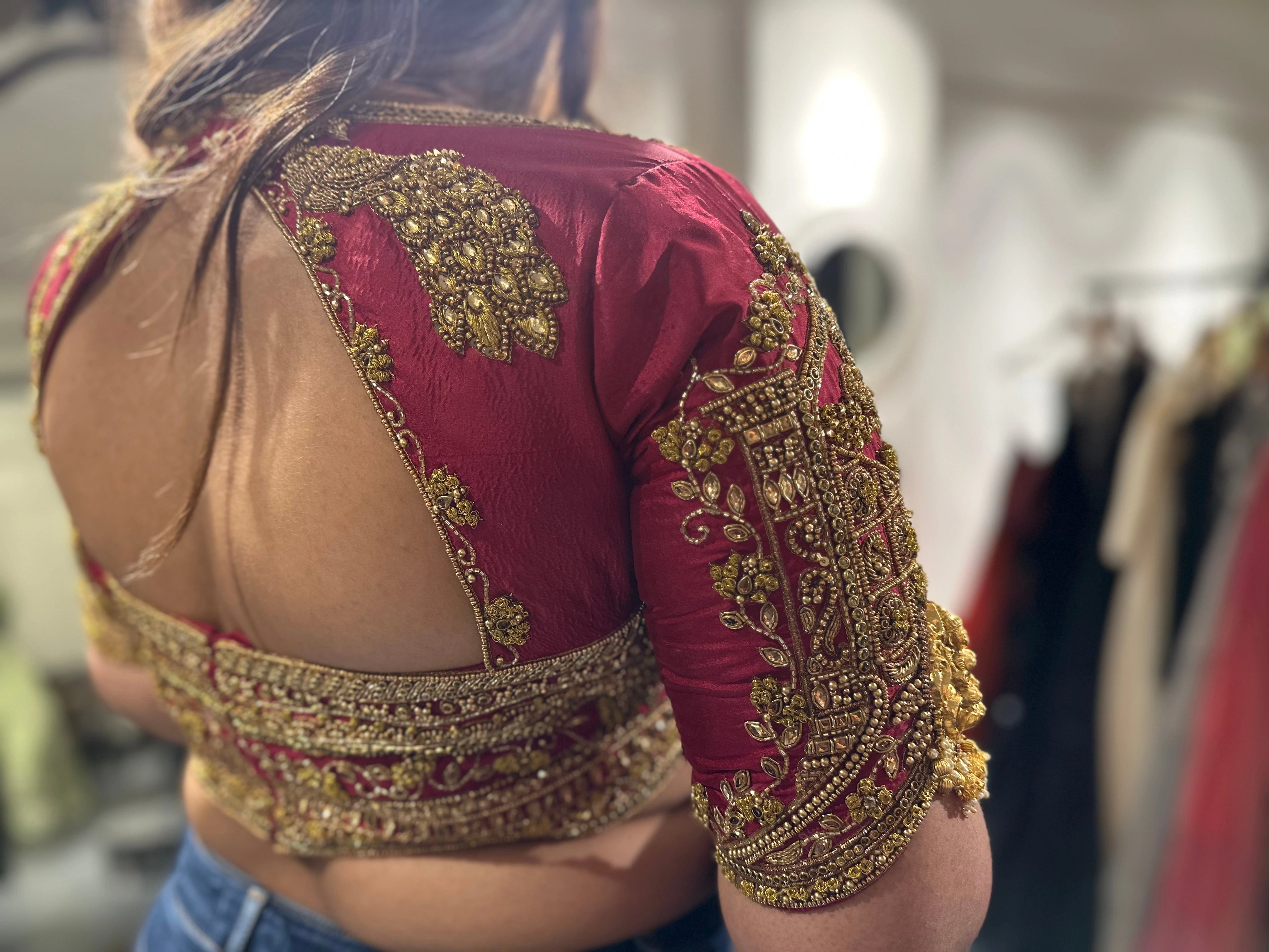 Bride Visali from USA during fittings in a red raw silk blouse handcrafted by team Archana Karthick.
