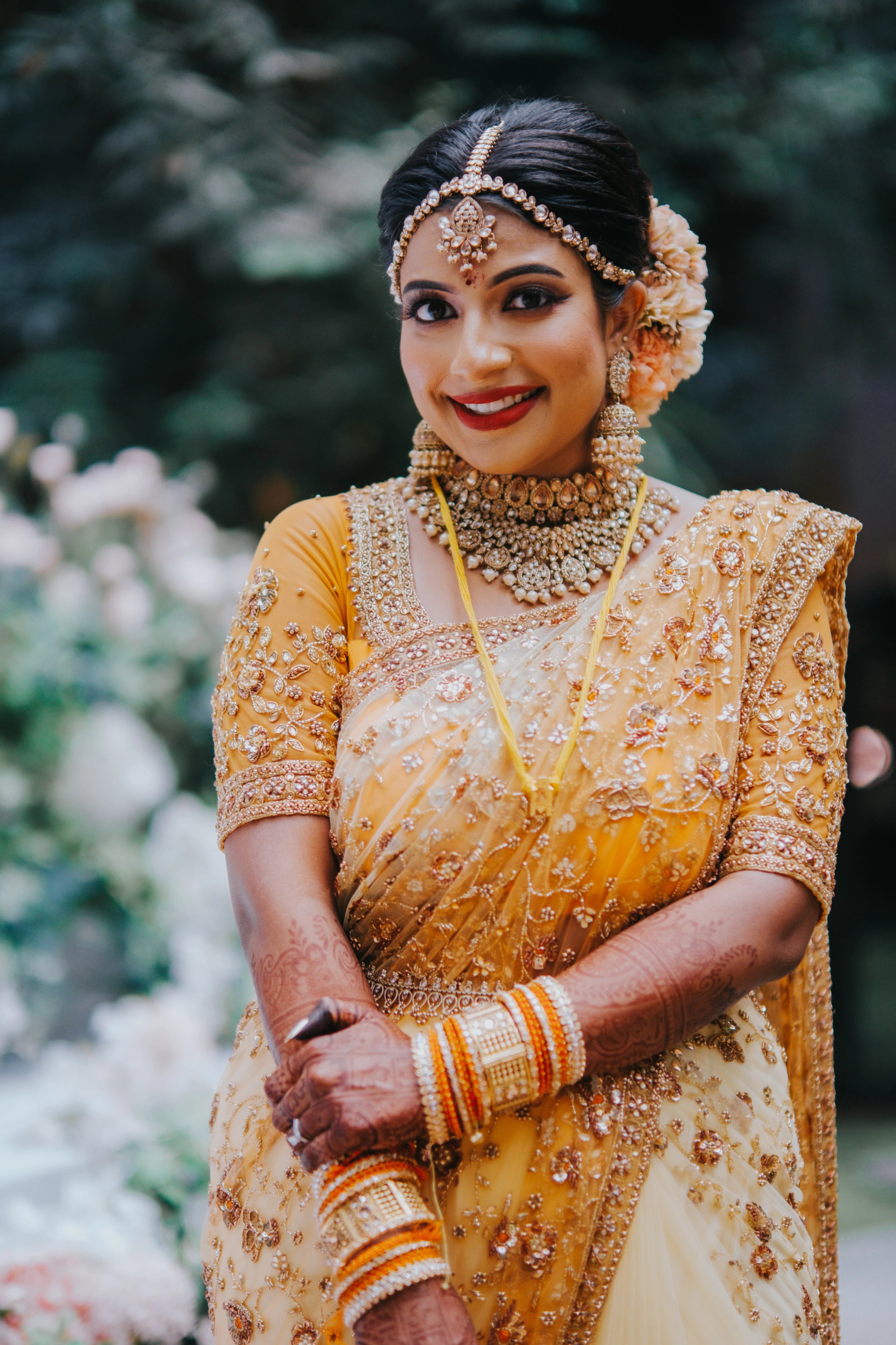 Bride Vishalini from Malaysia posing in a mustard and ivory tulle saree, handcrafted by team Archana Karthick.