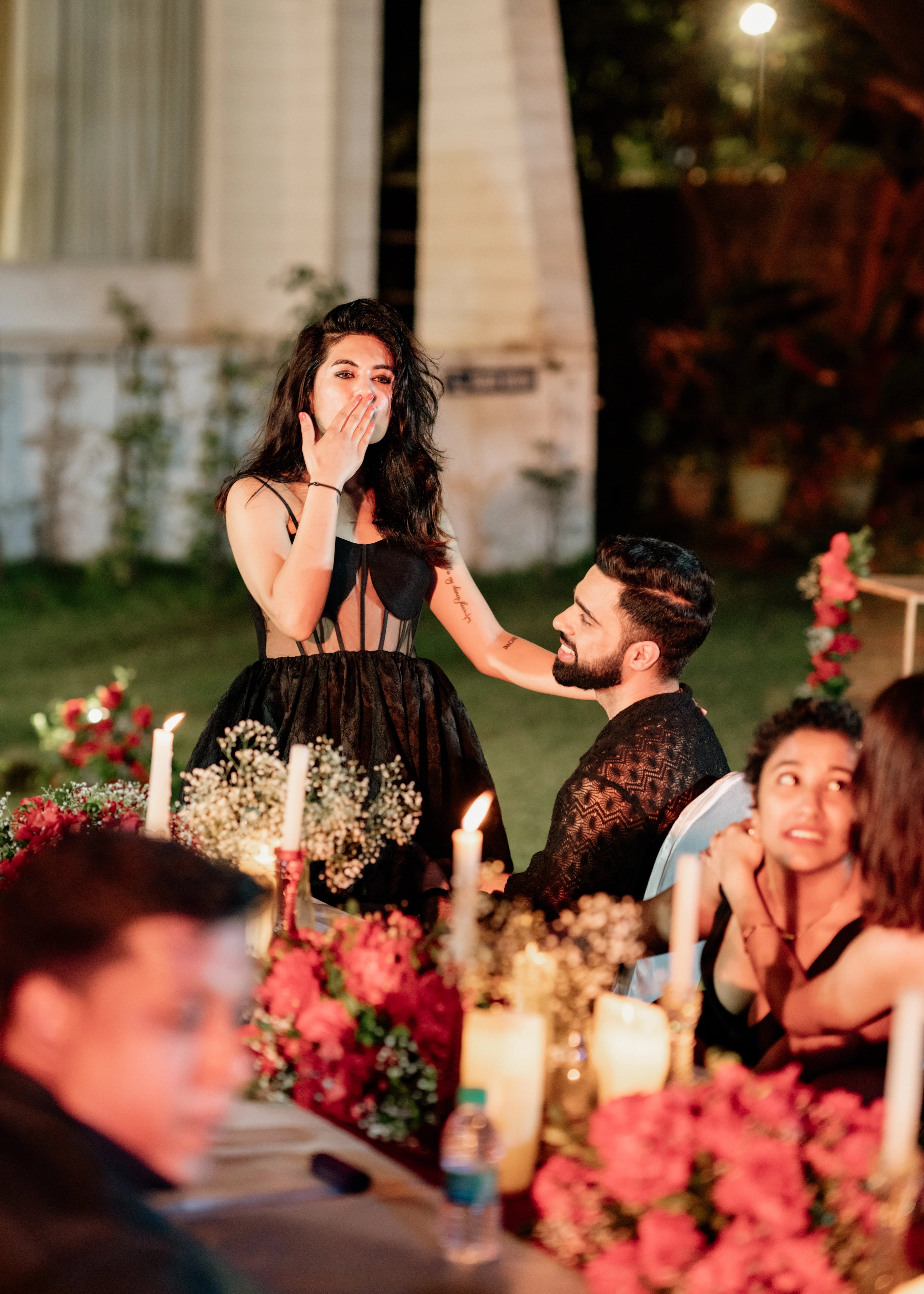 Bride celebrating in a black corset dress for her cocktail party, handcrafted in raw silk, tulle and jacquard. Designed by Archana Karthick