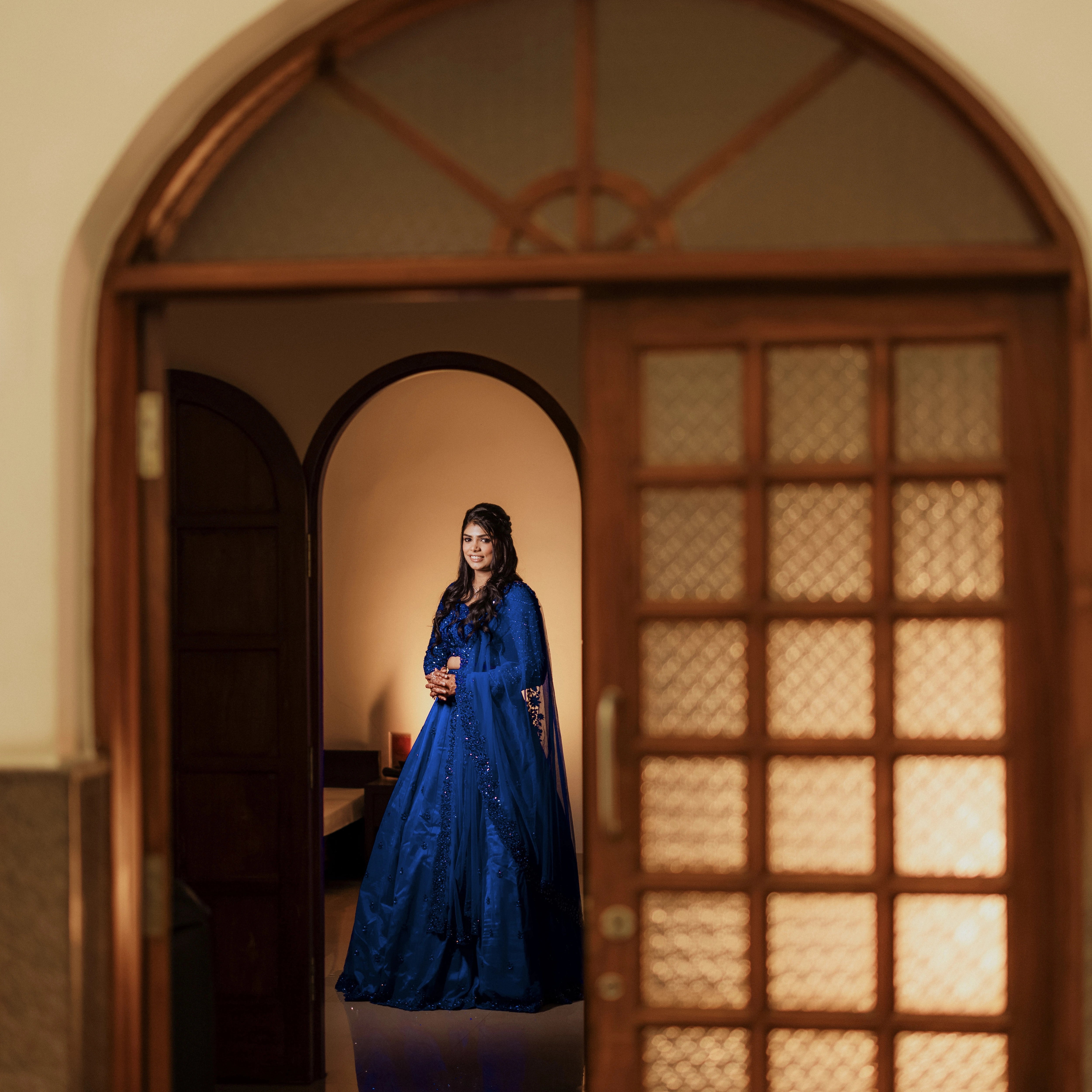 Bride Snegha from Australia in a blue tulle lehenga, handcrafted with sequins, cutdana, rhinestones and crystals by team Archana Karthick.