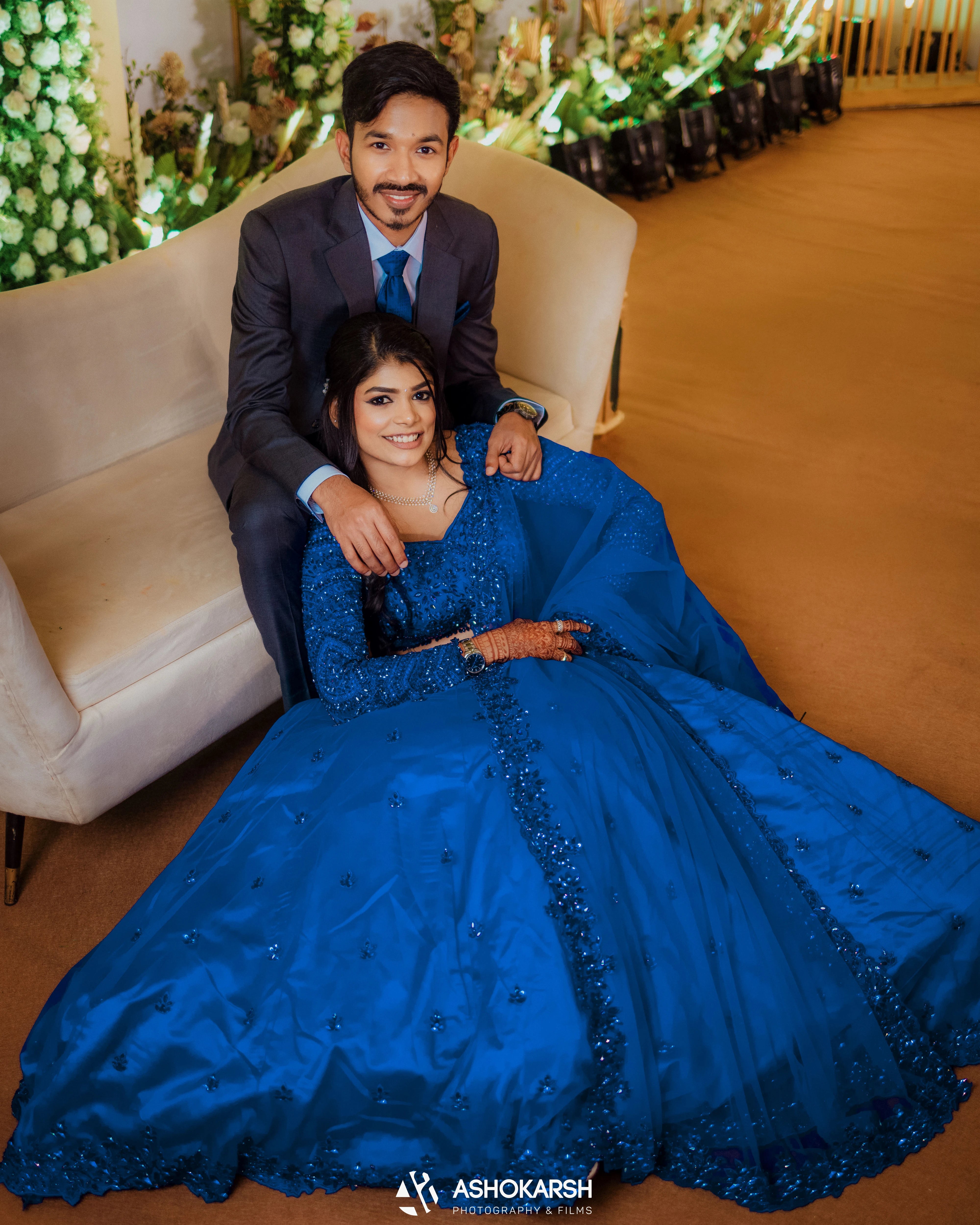 Bride Snegha from Australia with groom in a blue tulle lehenga, handcrafted with sequins, cutdana, rhinestones and crystals by team Archana Karthick.