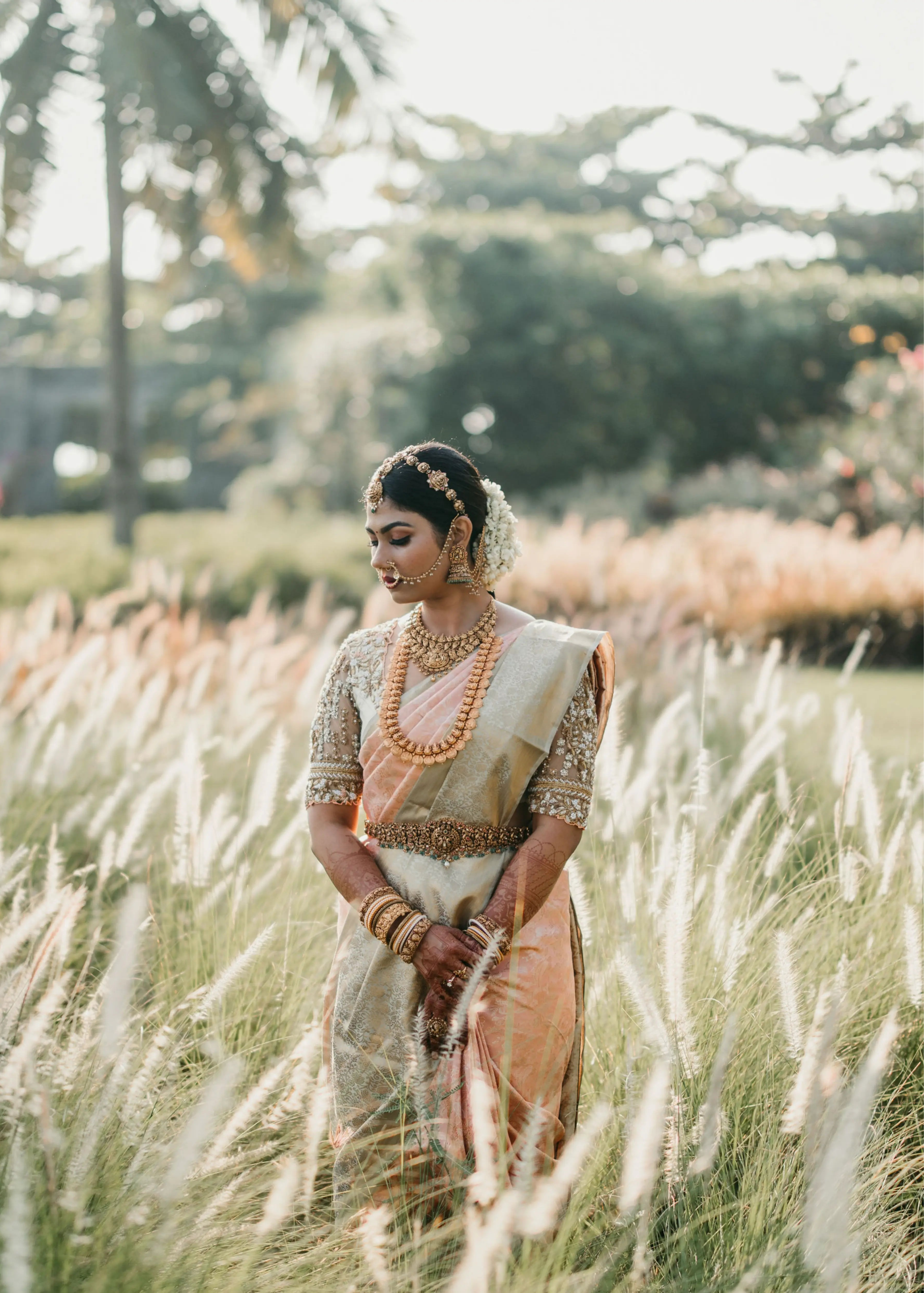 Bride in a concept blouse in grey tulle and silk, handcrafted intricately with zardozi, crystal beads, stones, pearls and beads. Designed by Archana Karthick.