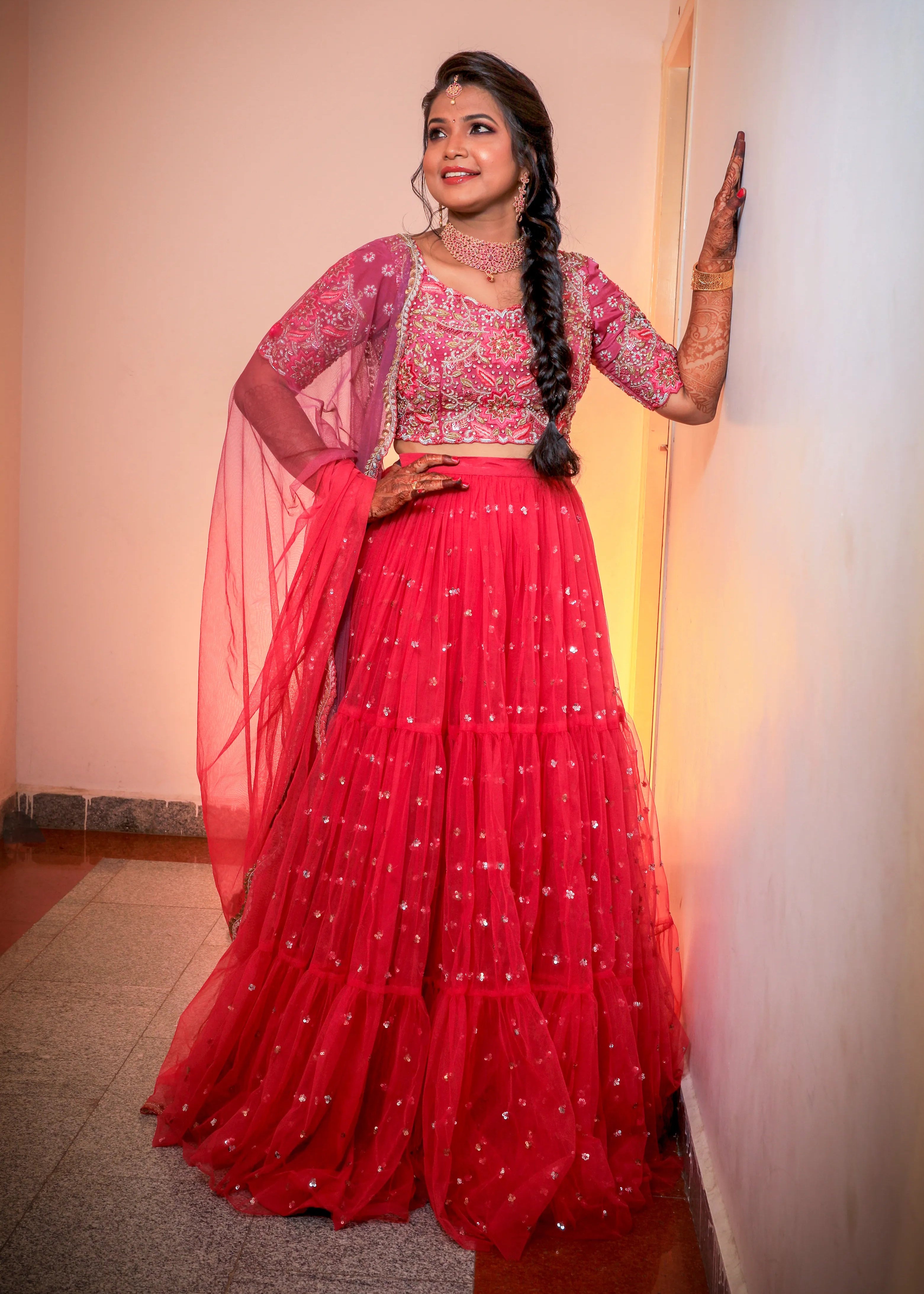 Bride from Chennai in a handcrafted pink tulle with heavily embellished blouse with zardozi, rhinestones, cut dana, sequin and resham knot work.