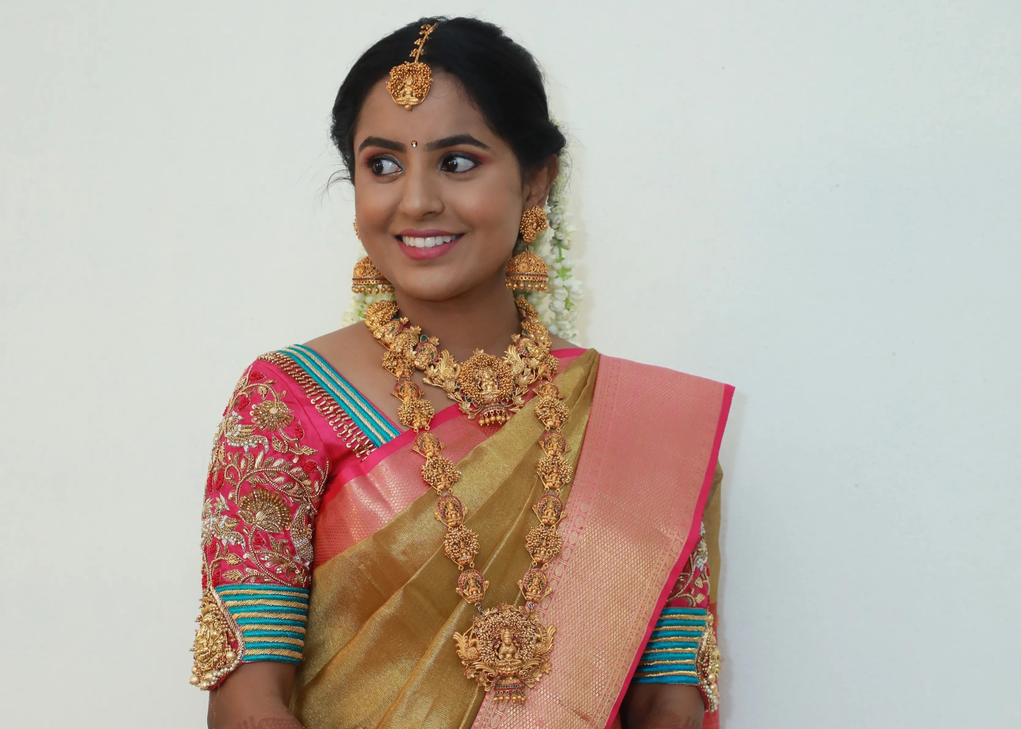 Bride from Chennai in pink silk blouse with zardozi, kundan, resham knot work and kundan embellishments. Designed by Archana Karthick
