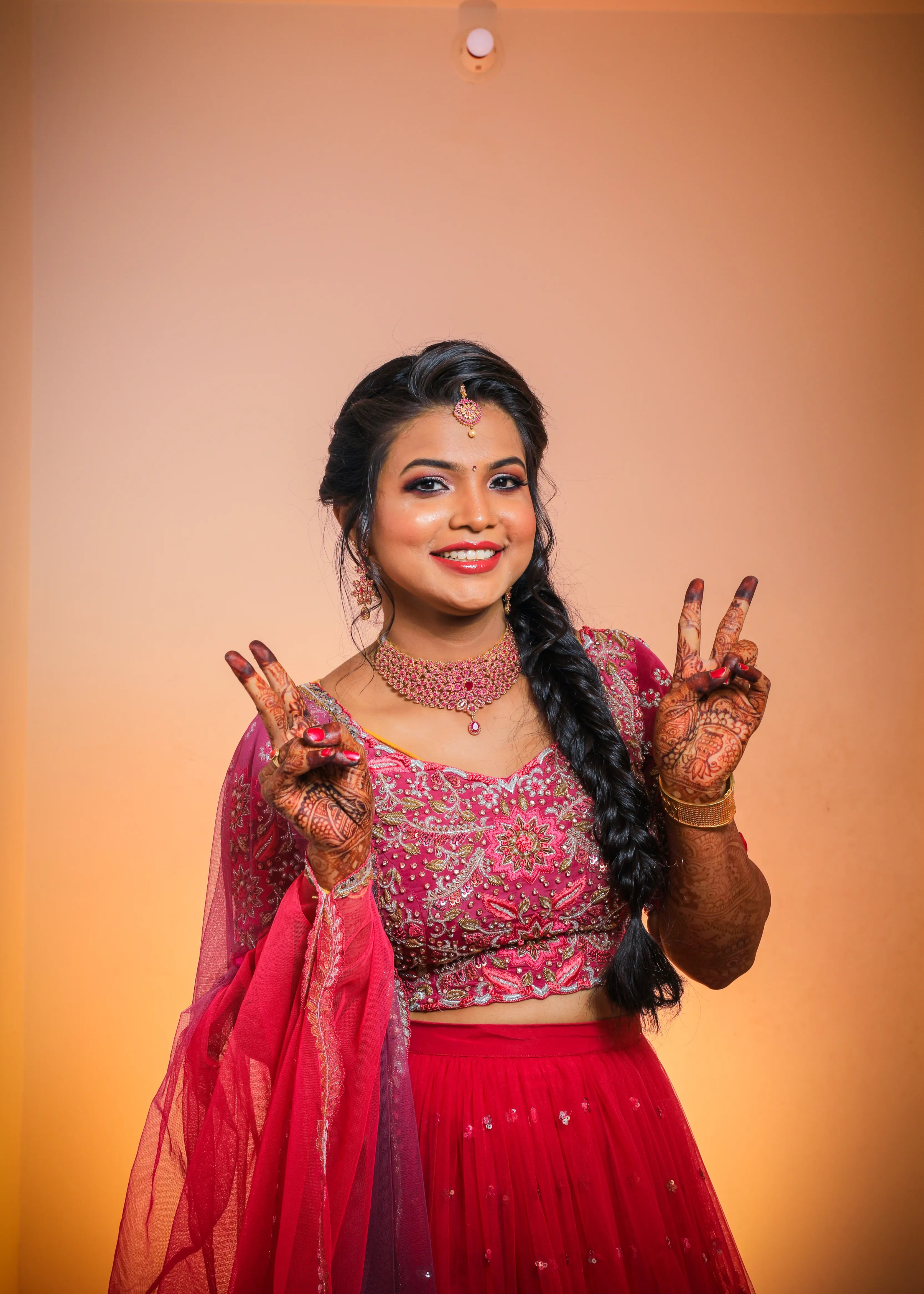 Bride from Chennai posing in a handcrafted pink tulle with heavily embellished blouse with zardozi, rhinestones, cut dana, sequin and resham knot work.