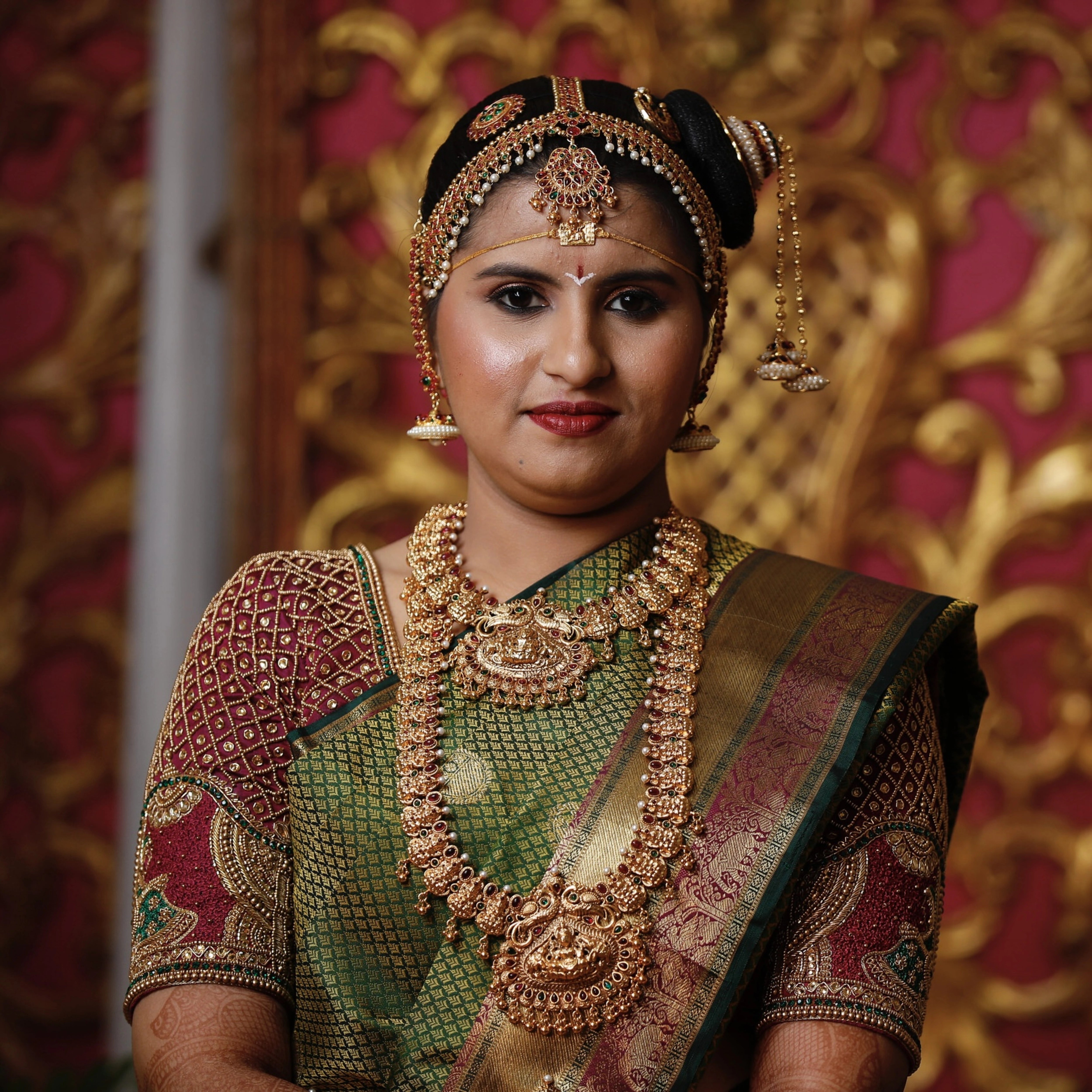 Bride from Chennai posing on stage in a silk blouse designed by Archana Karthick handcrafted intricately with zardozi, beads, resham and kundan.