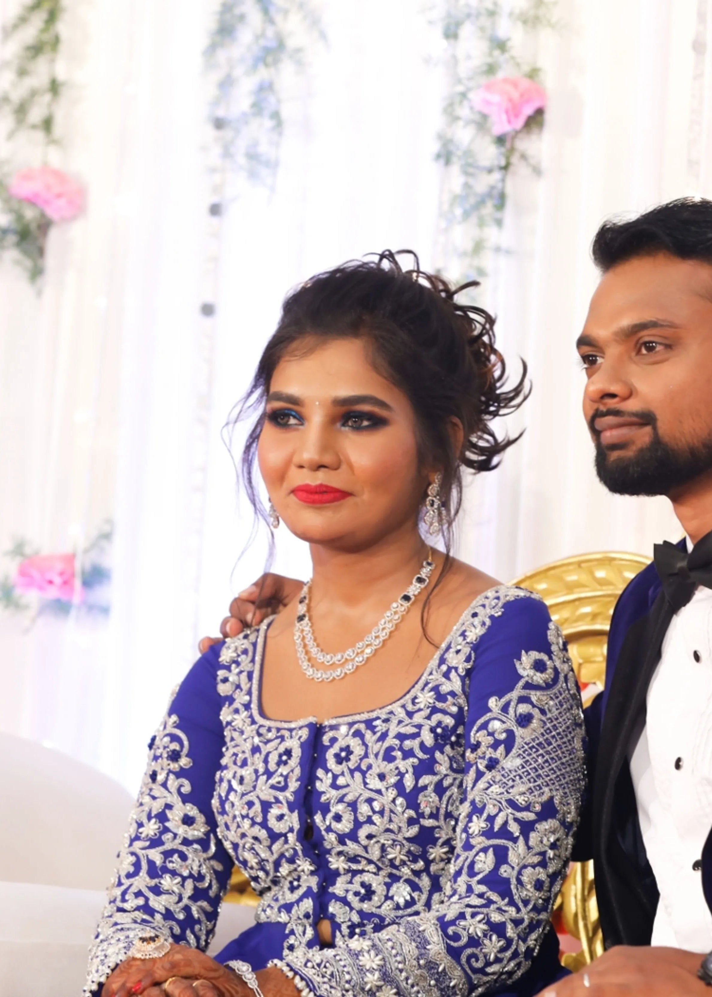 Bride from Chennai smiling in navy blue masakali lehenga with silver embellishments designed by Archana Karthick