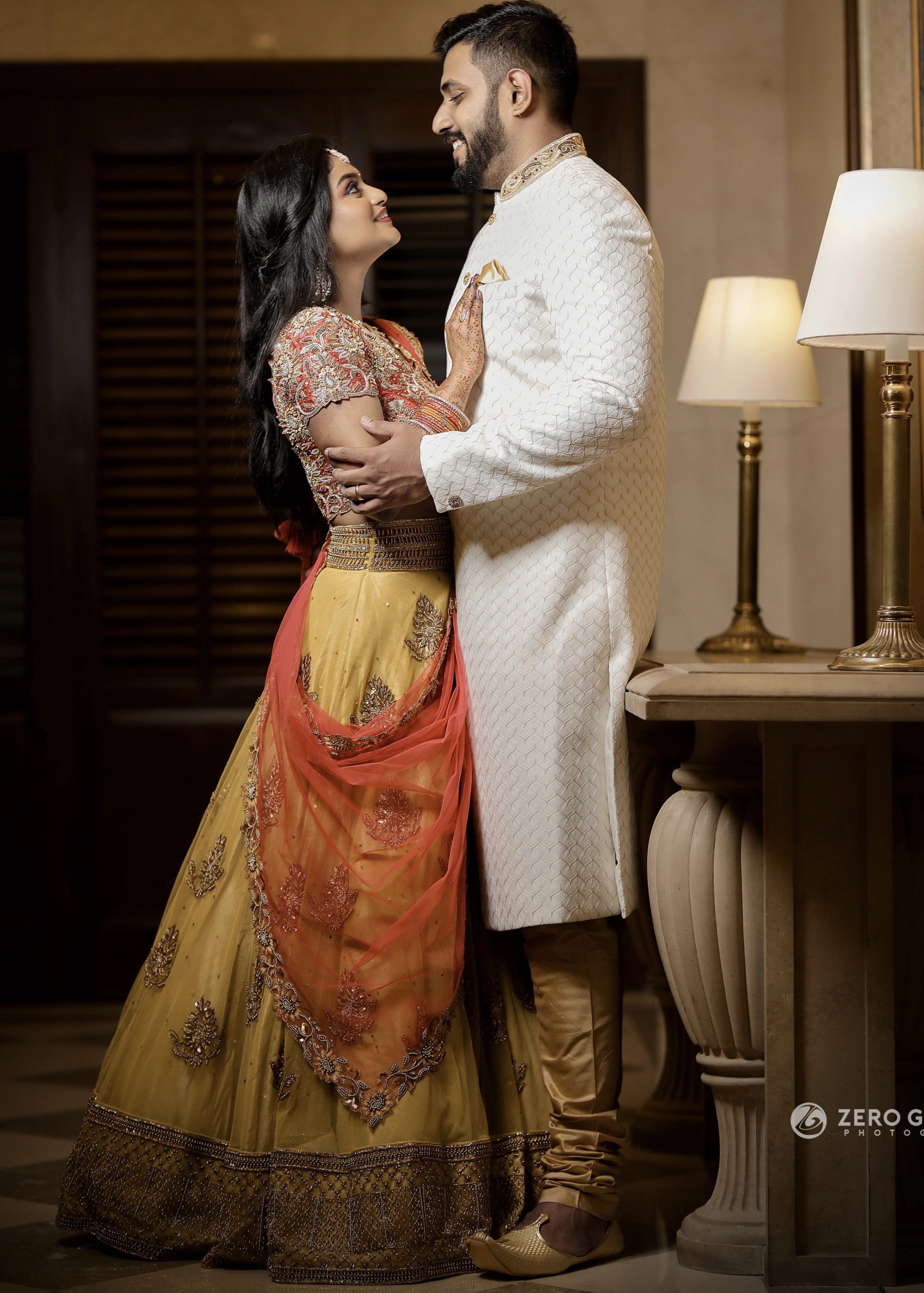 Bride from Chennai with groom in a yellow tulle skirt and dupatta and red raw silk blouse which make up the lehenga handcrafted intricately. Designed by Archana Karthick.