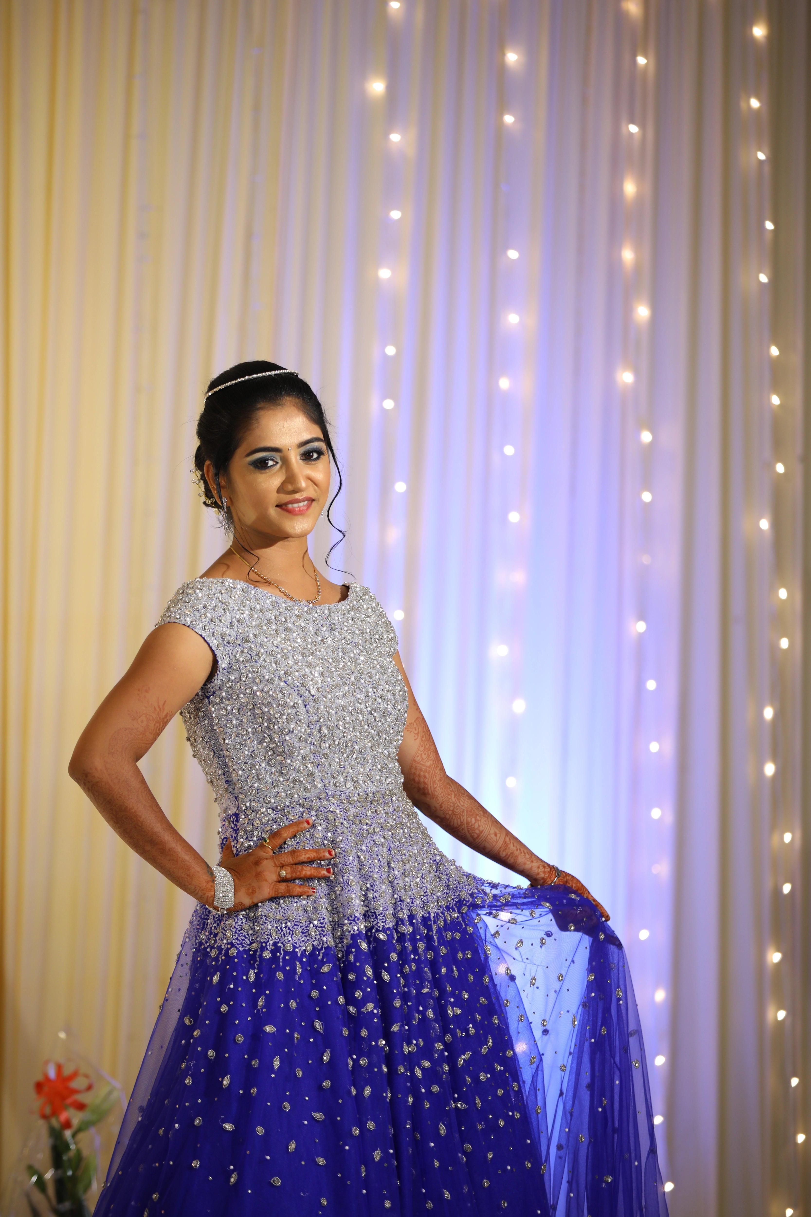 Bride from Coimbatore posing sideways in a concept gown in tulle designed by Archana Karthick handcrafted intricately with stones, cutdana and sequins.