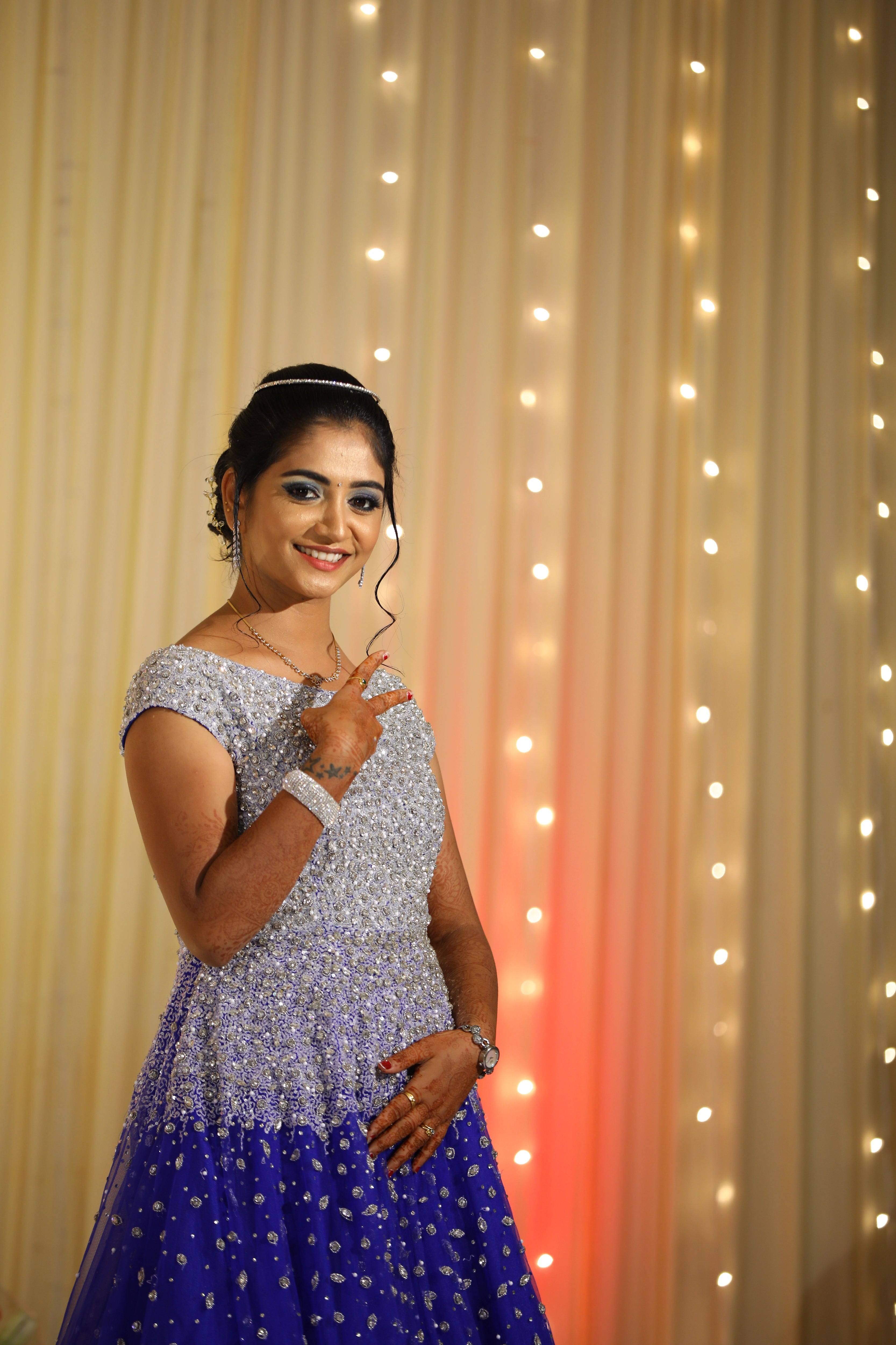 Bride from Coimbatore smiling and posing in a concept gown in tulle designed by Archana Karthick handcrafted intricately with stones, cutdana and sequins.