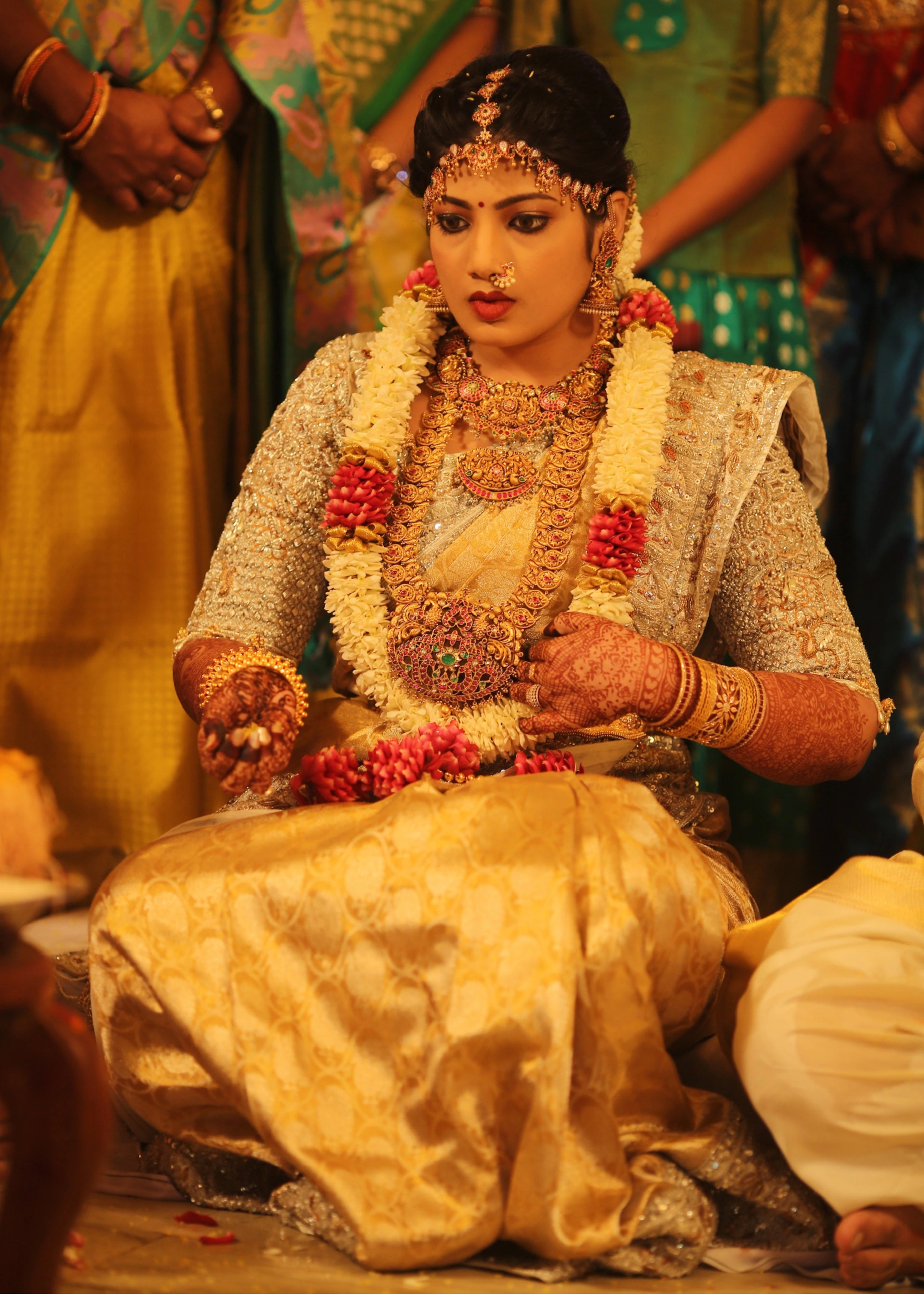 Bride from Kuwait during ritual in a silver silk blouse and saree border handcrafted with stones, crystals, zardozi, beads, rhinestones, cutdanas and sequins. Designed by Archana Karthick.