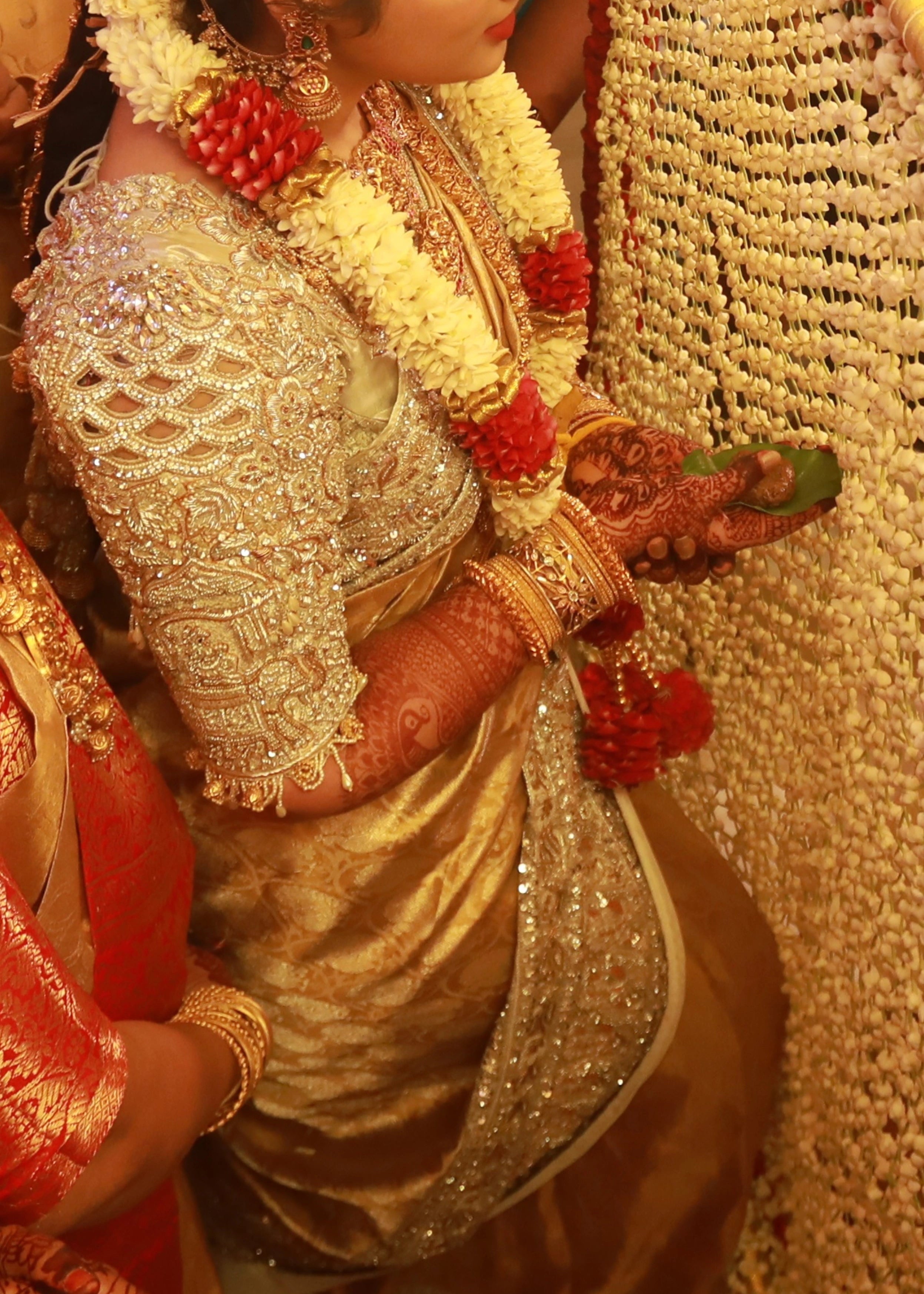 Bride from Kuwait in a silver silk blouse and saree border handcrafted with stones, crystals, zardozi, beads, rhinestones, cutdanas and sequins. Designed by Archana Karthick.
