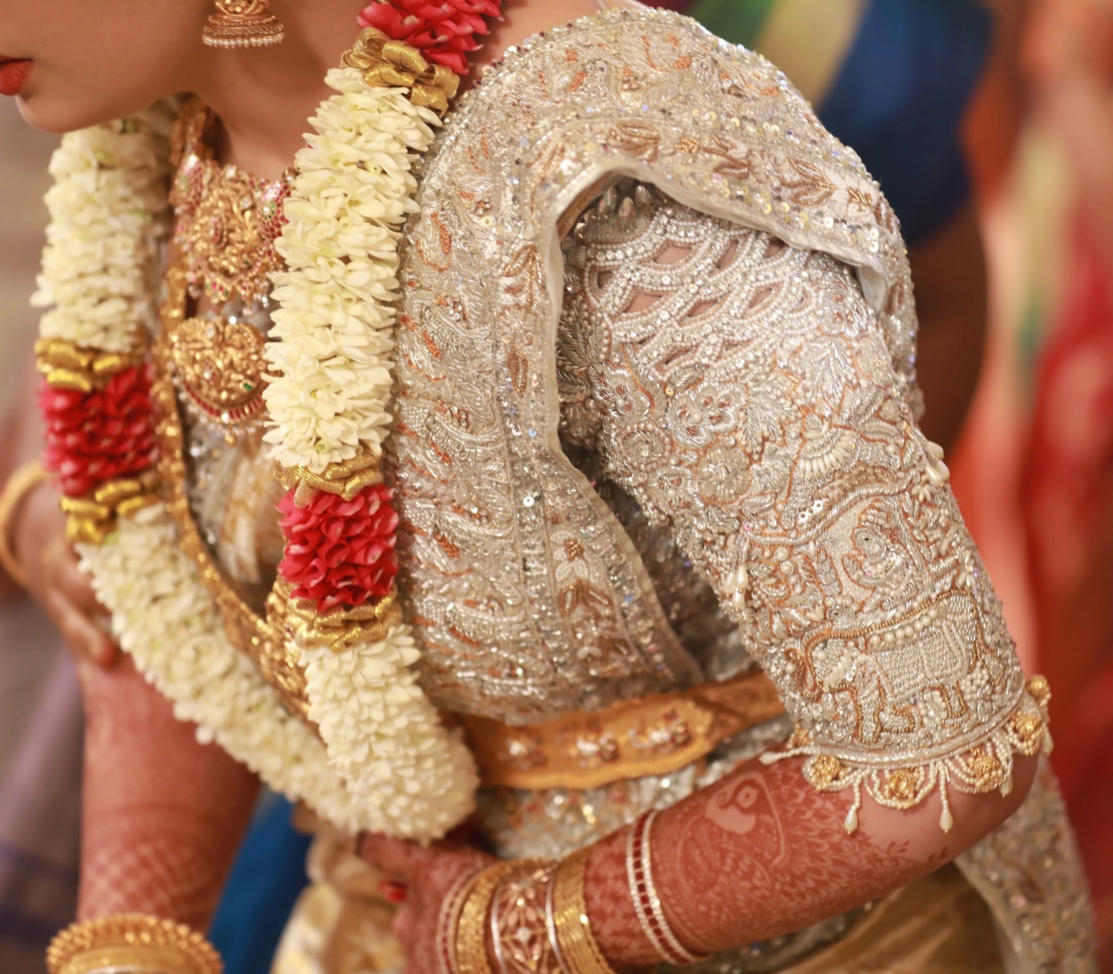 Bride from Kuwait posing in a silver silk blouse and saree border handcrafted with stones, crystals, zardozi, beads, rhinestones, cutdanas and sequins. Designed by Archana Karthick.