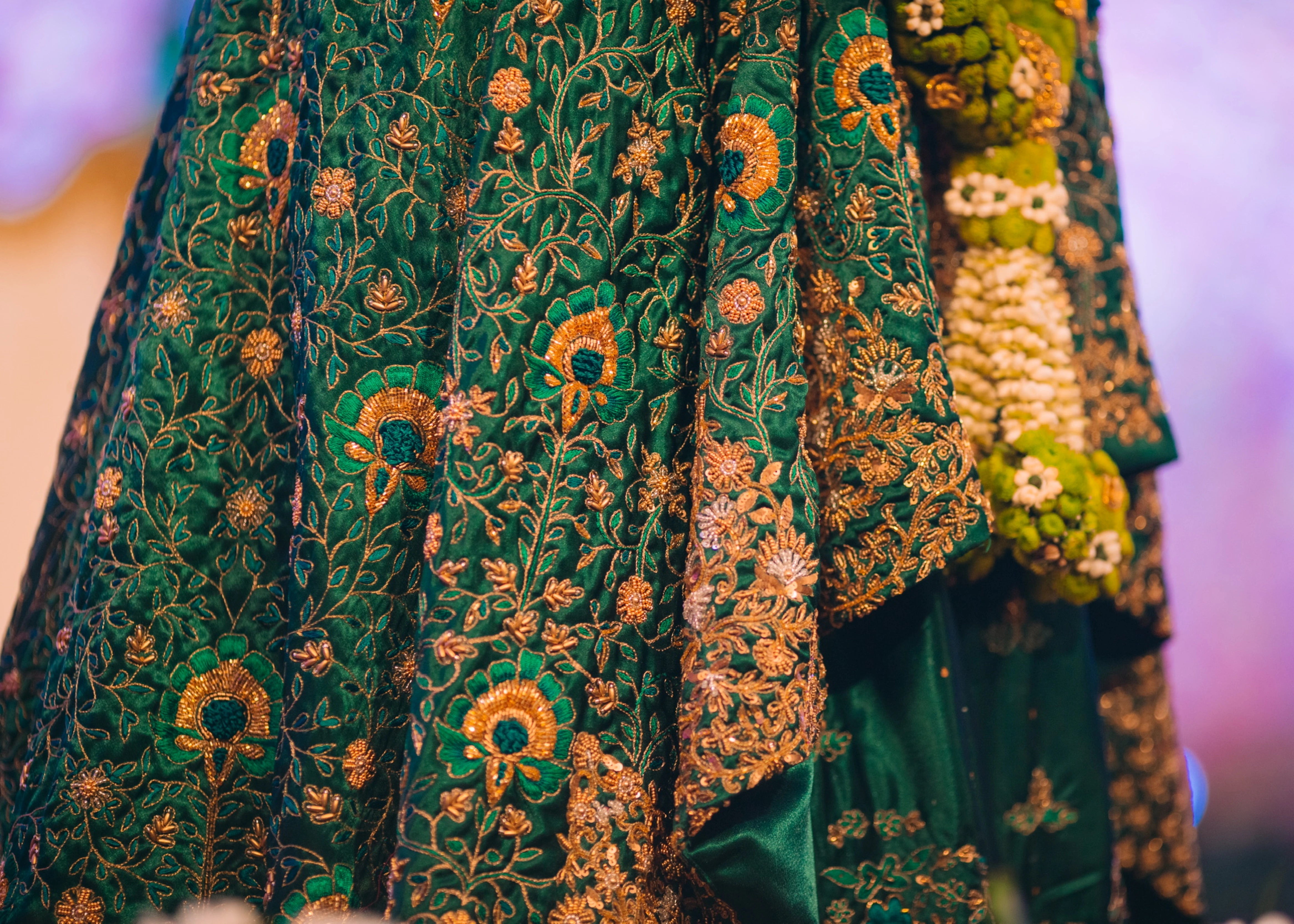Bride from Kuwait showcasing intricacy in a bottle green satin silk masakali lehenga handcrafted with zardozi, rhinestones, crystals and more. Designed by Archana Karthick.