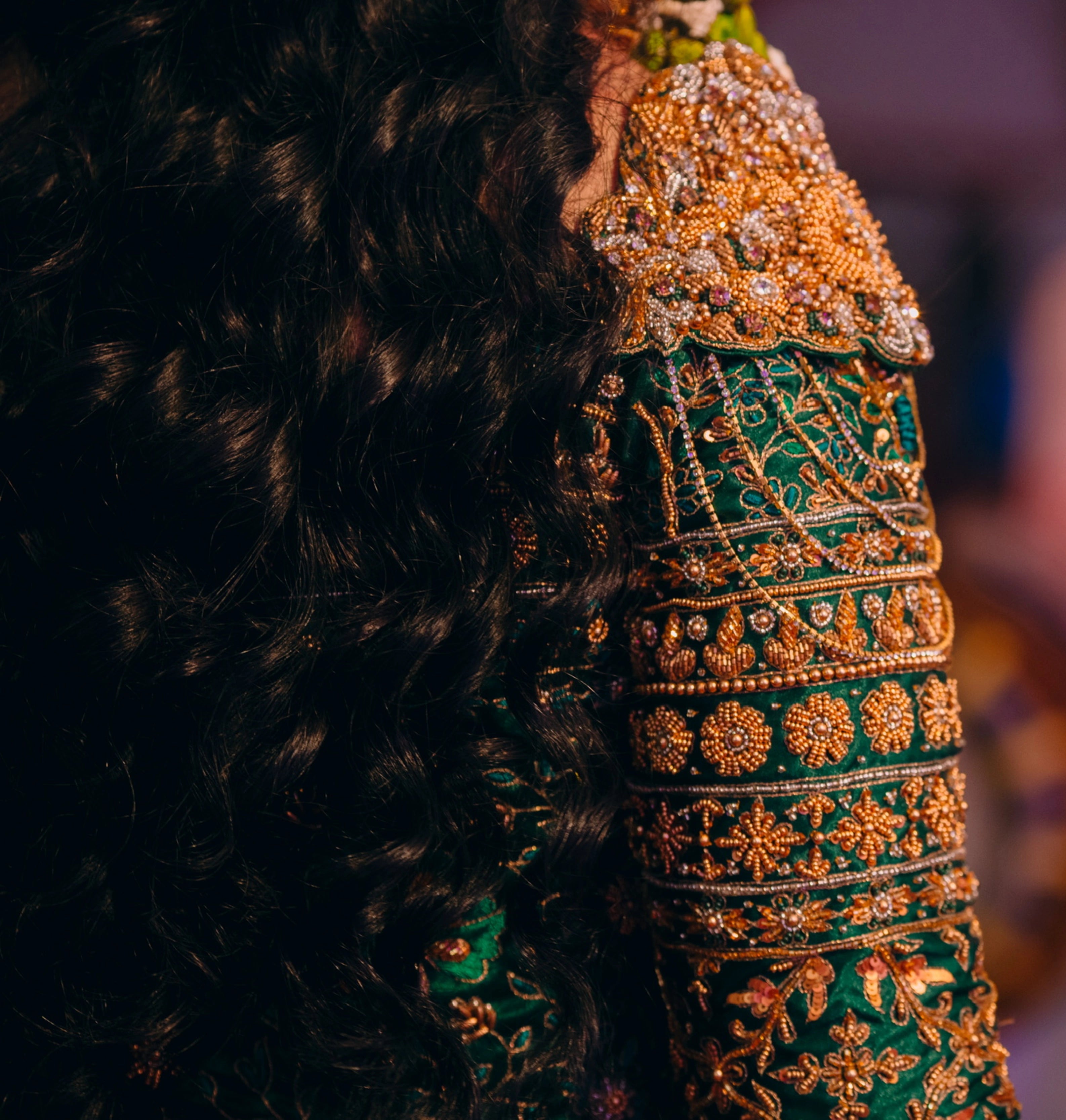 Bride from Kuwait showcasing sleeve in a bottle green satin silk masakali lehenga handcrafted with zardozi, rhinestones, crystals and more. Designed by Archana Karthick.