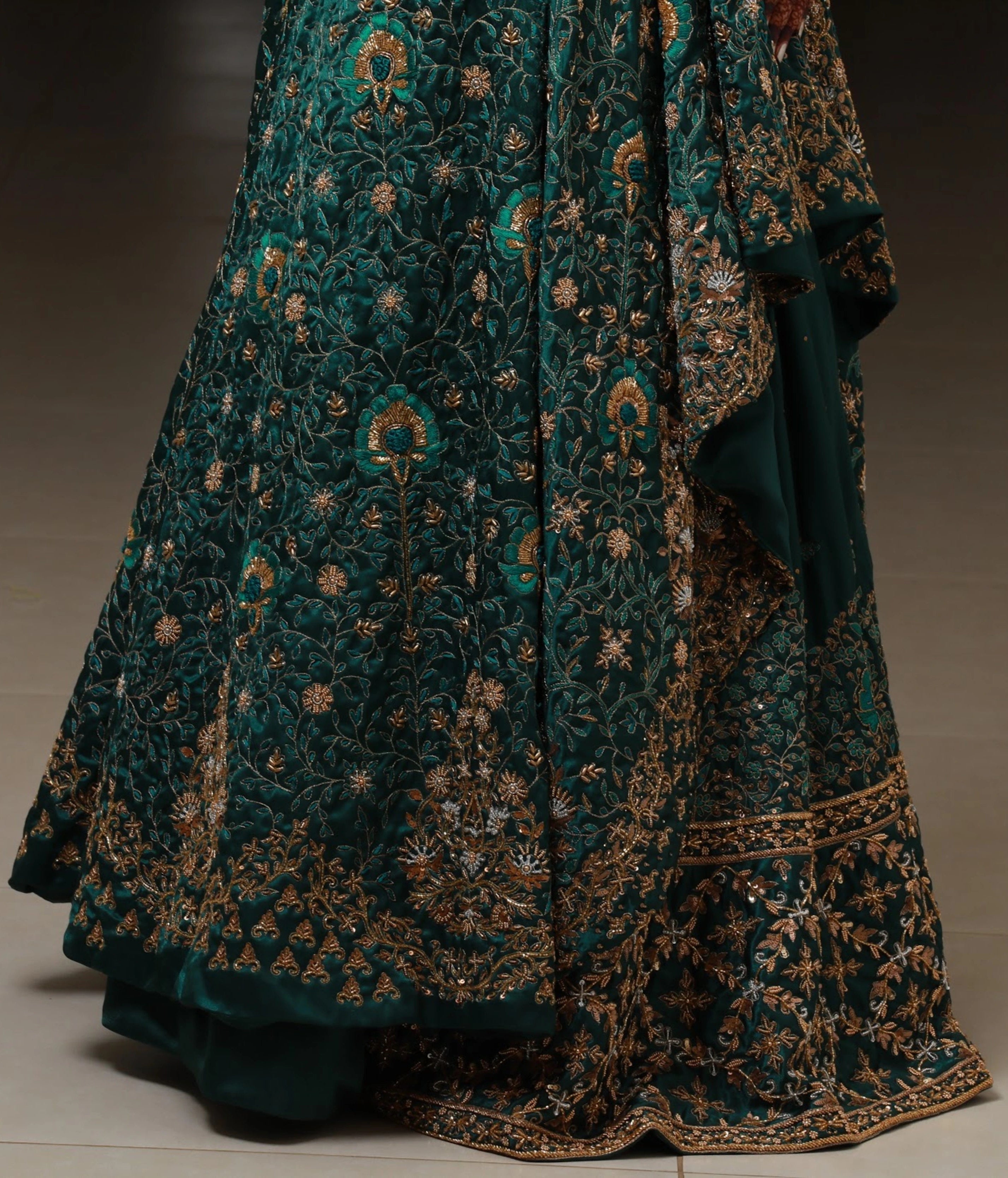 Bride from Kuwait showcasing the work in a bottle green satin silk masakali lehenga handcrafted with zardozi, rhinestones, crystals and more. Designed by Archana Karthick.