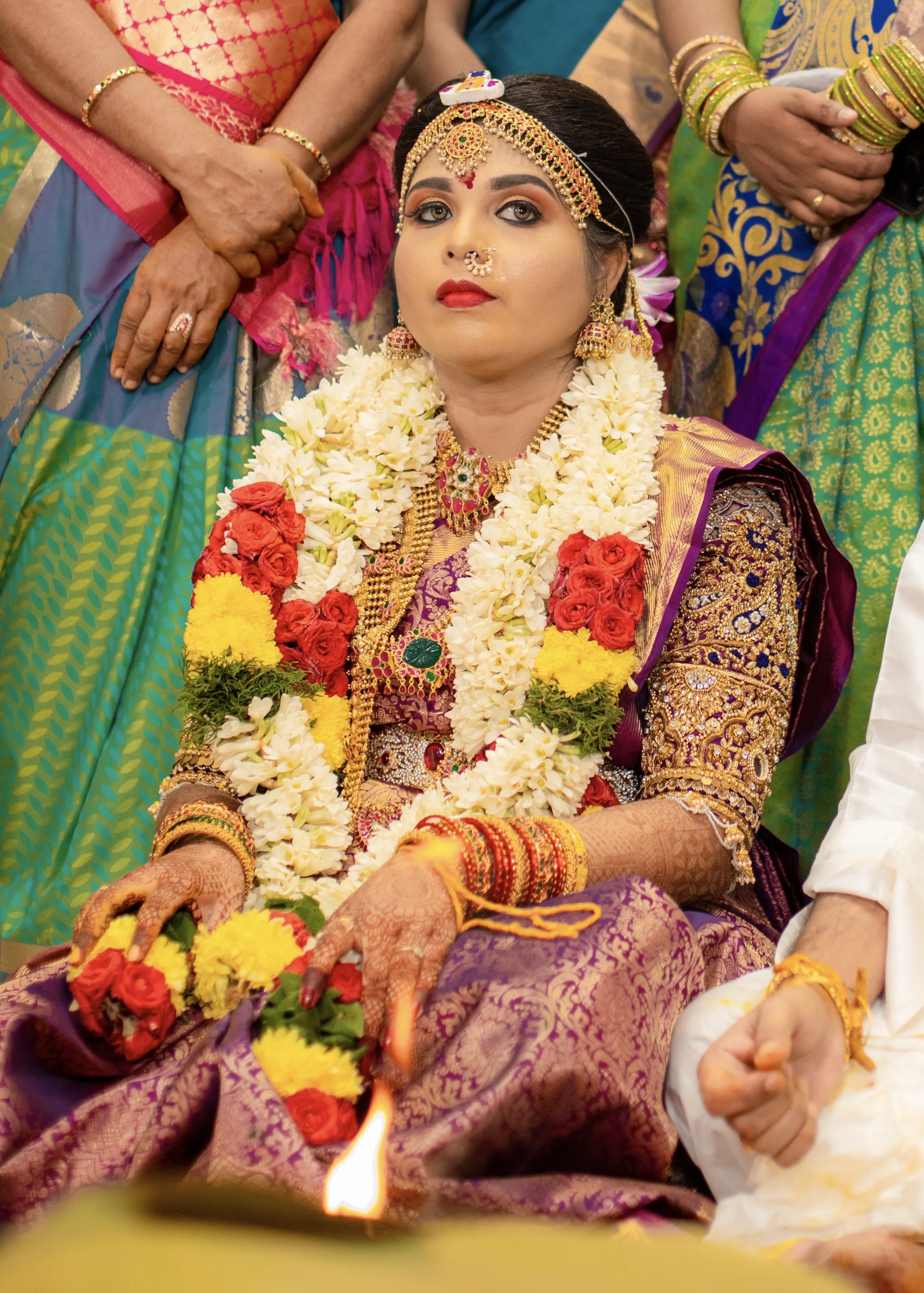 Bride from Salem in a purple silk blouse handcrafted with stone work, zardozi, beads, mirror work resham knot work and jhumki detailings.
