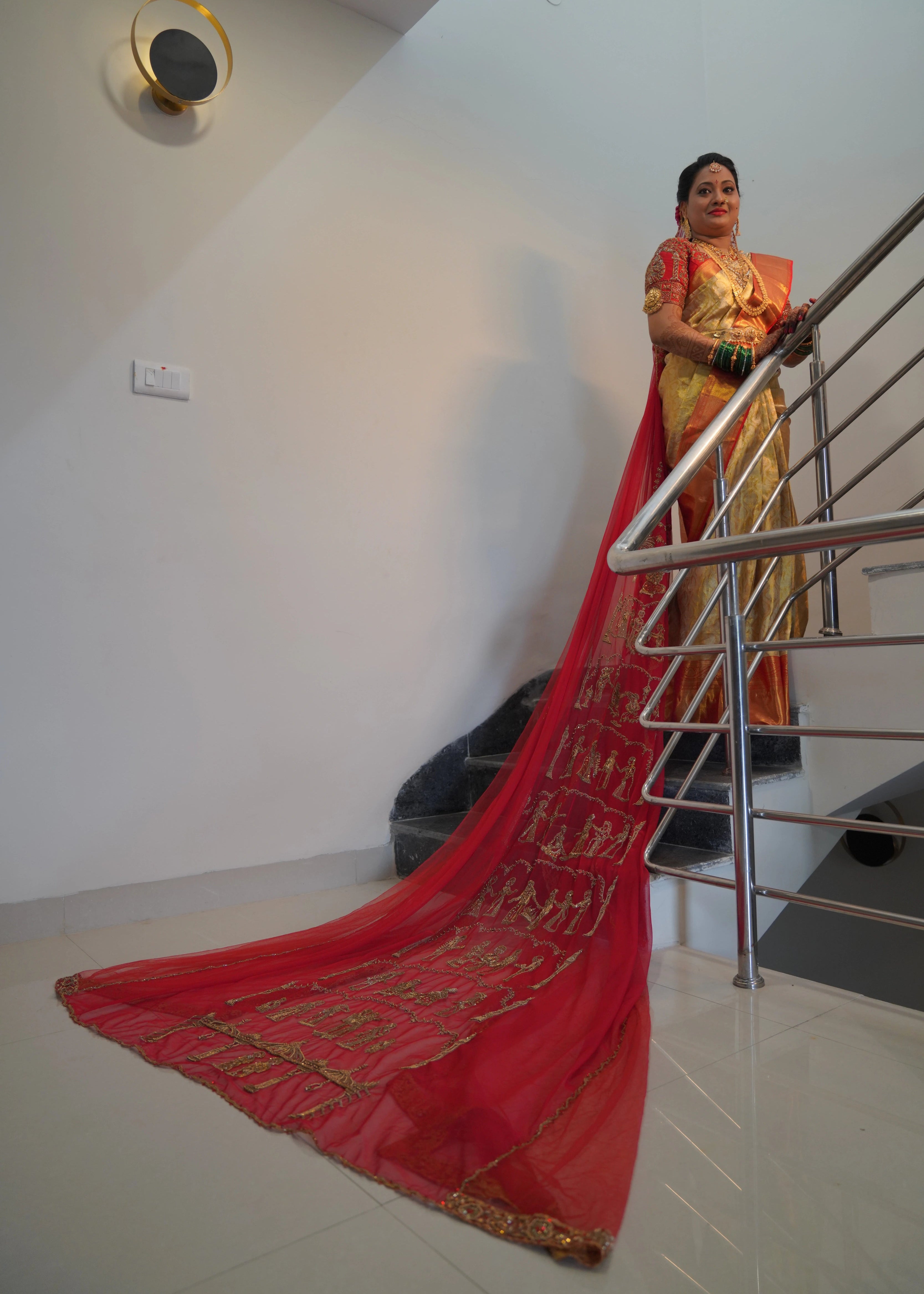 Bride from Seattle posing in a concept red raw silk blouse and tulle veil handcrafted intricately with zardozi, beads, stones and sequins. Designed by Archana Karthick