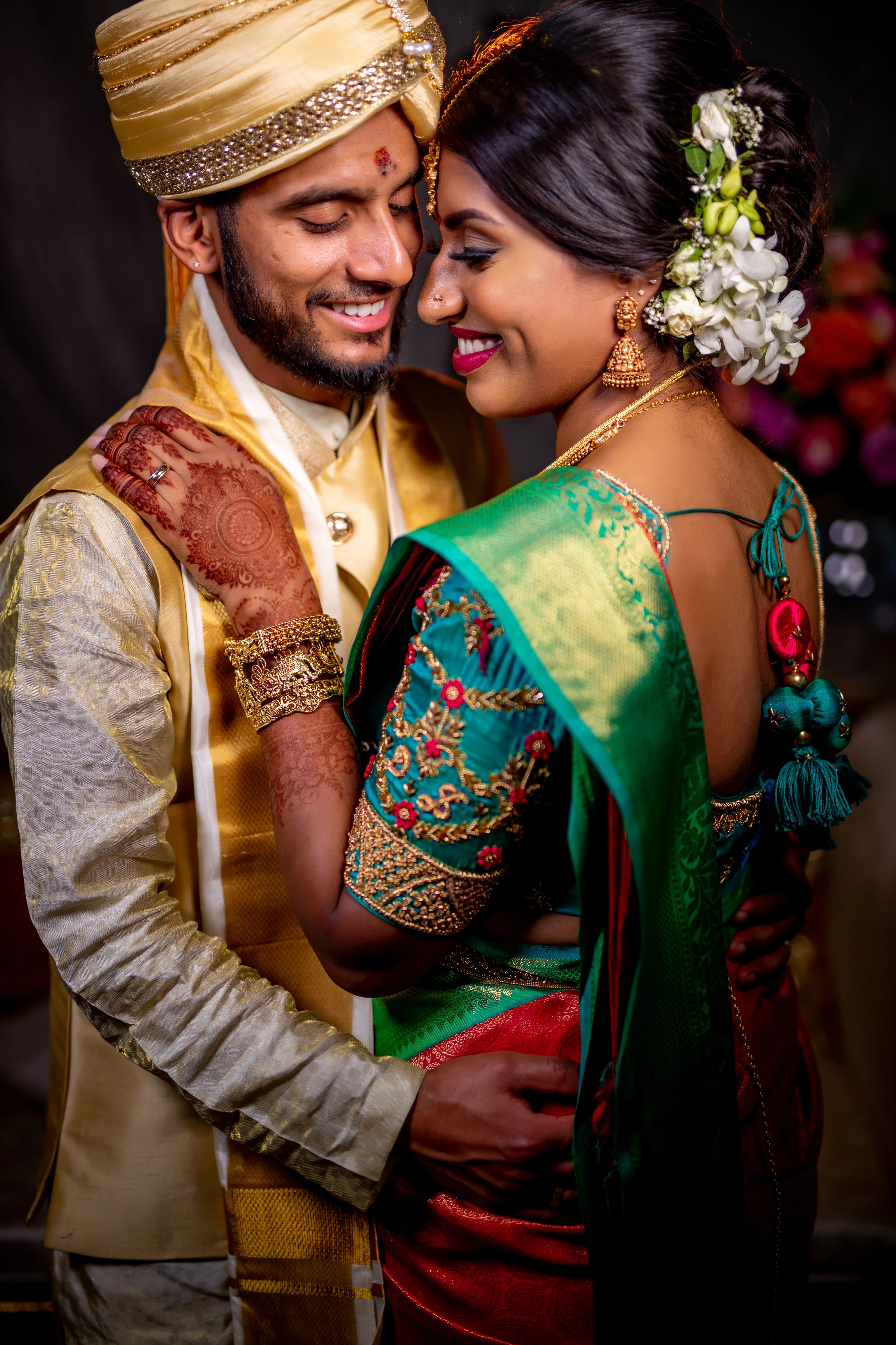 Bride from UK with groom in an aquamarine silk blouse for her wedding. Handcrafted intricately with beads, zardozi and resham knot work by team Archana Karthick.
