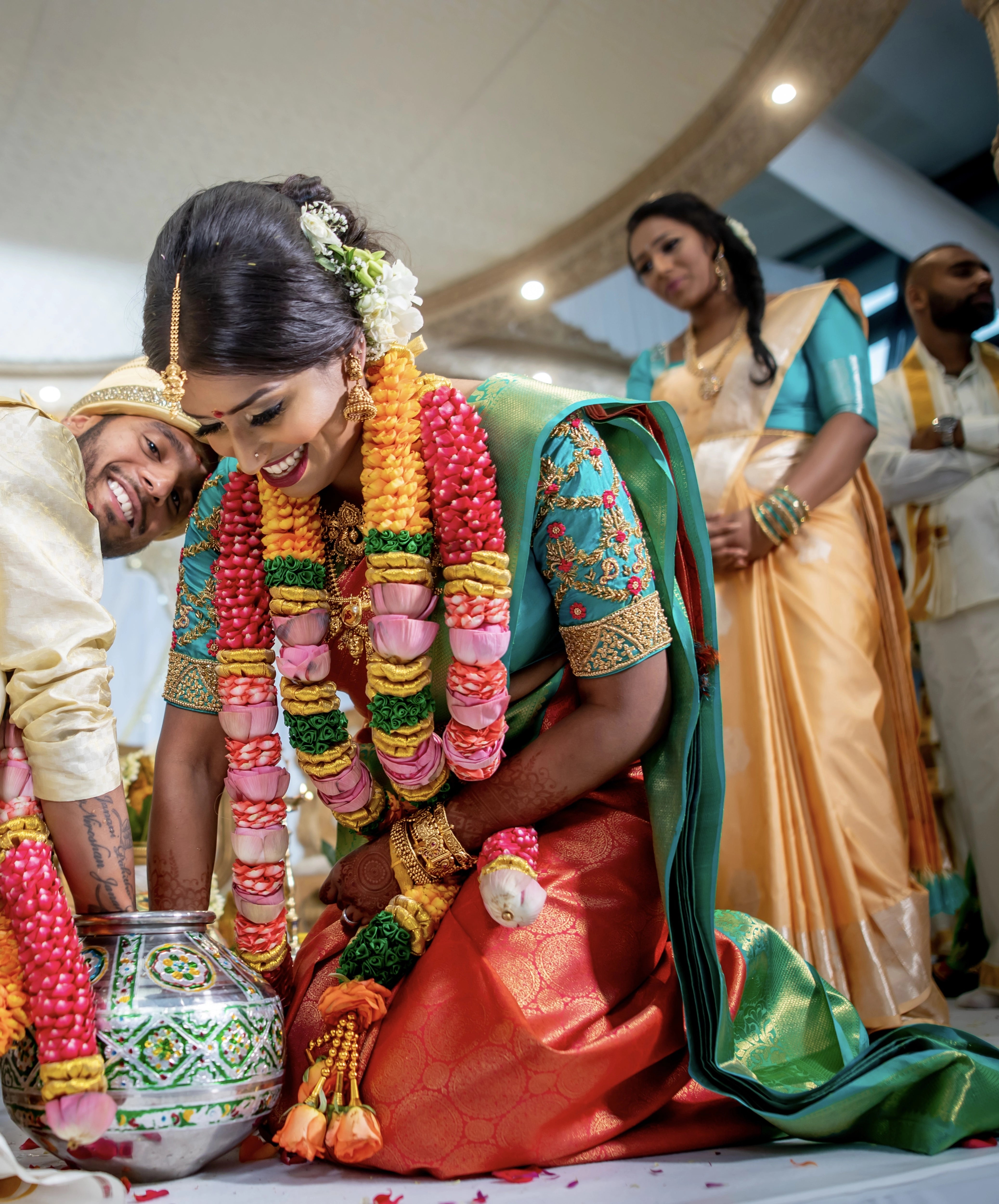 Bride from UK with groom on stage in an aquamarine silk blouse for her wedding. Handcrafted intricately with beads, zardozi and resham knot work by team Archana Karthick.