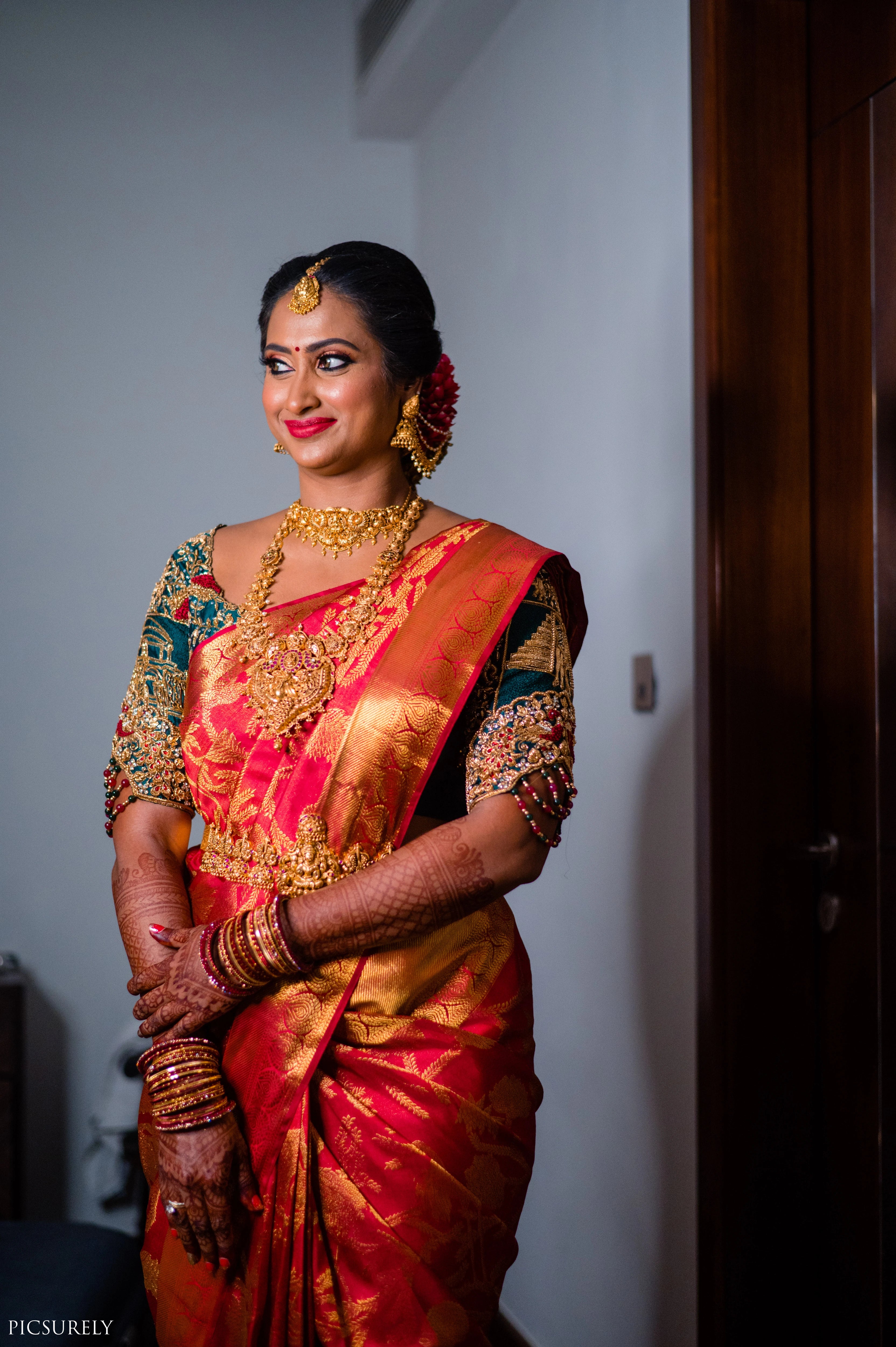 Bride from USA in a bottle green raw silk concept blouse for her wedding, handcrafted with zardozi, stones, beads, resham work and kundan by Archana Karthick.
