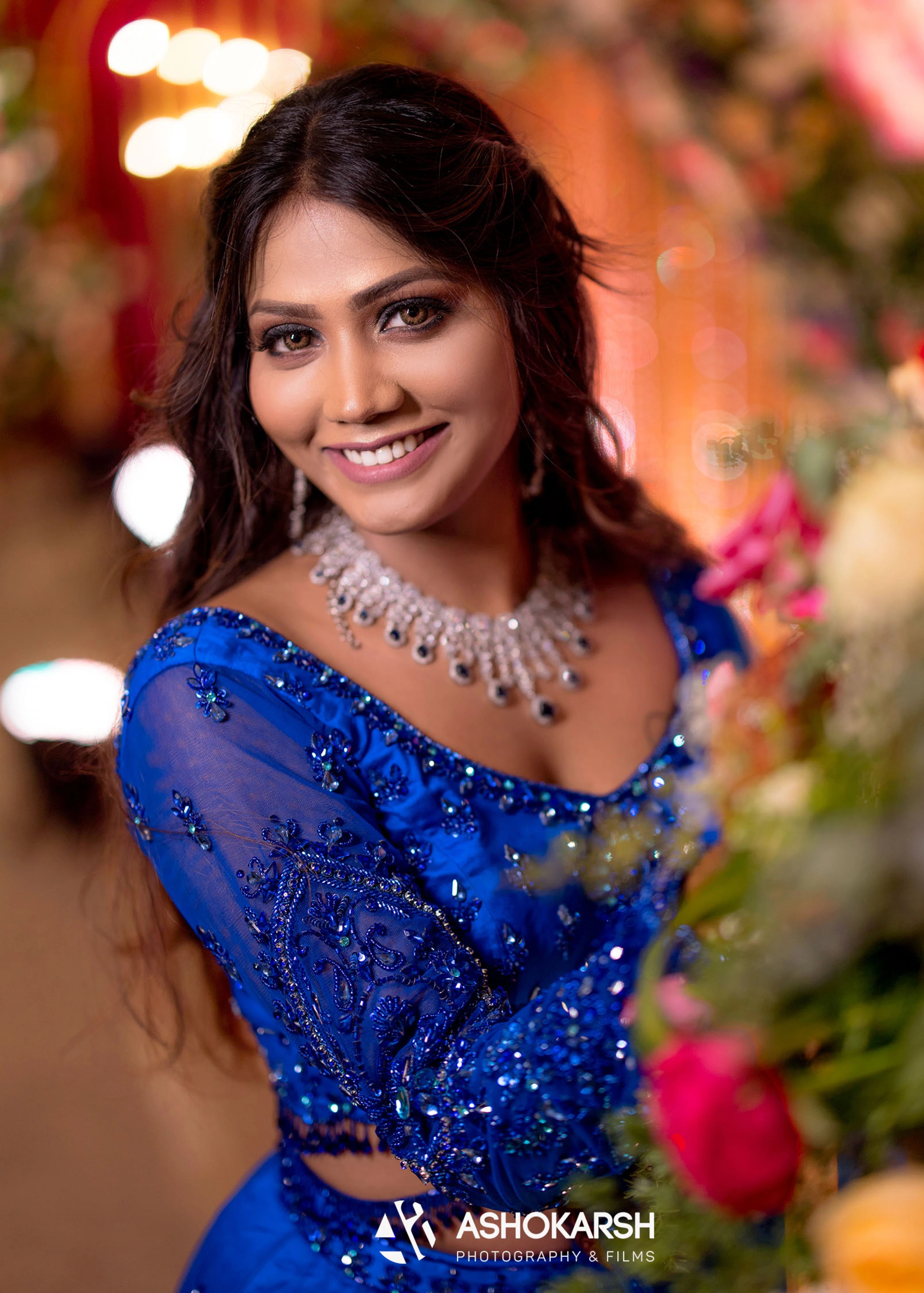 Bride from USA in a closeup in a concept blue lehenga handcrafted intricately with rhinestones, crystal beads, cutdanas and sequins.