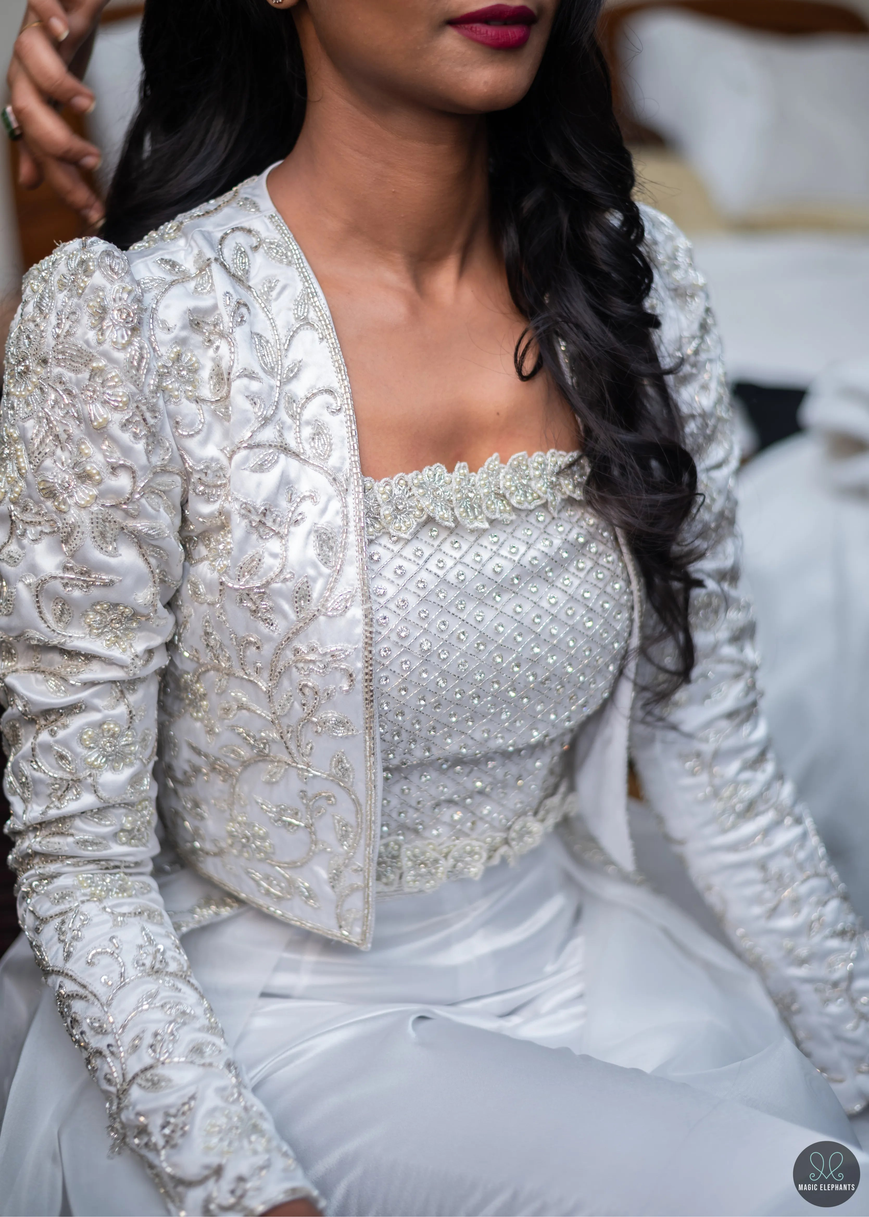 Bride getting ready for her party in handcrafted silver satin and organza corset outfit embellished with cut dana, pearls, stones and sequins. Designed by Archana Karthick