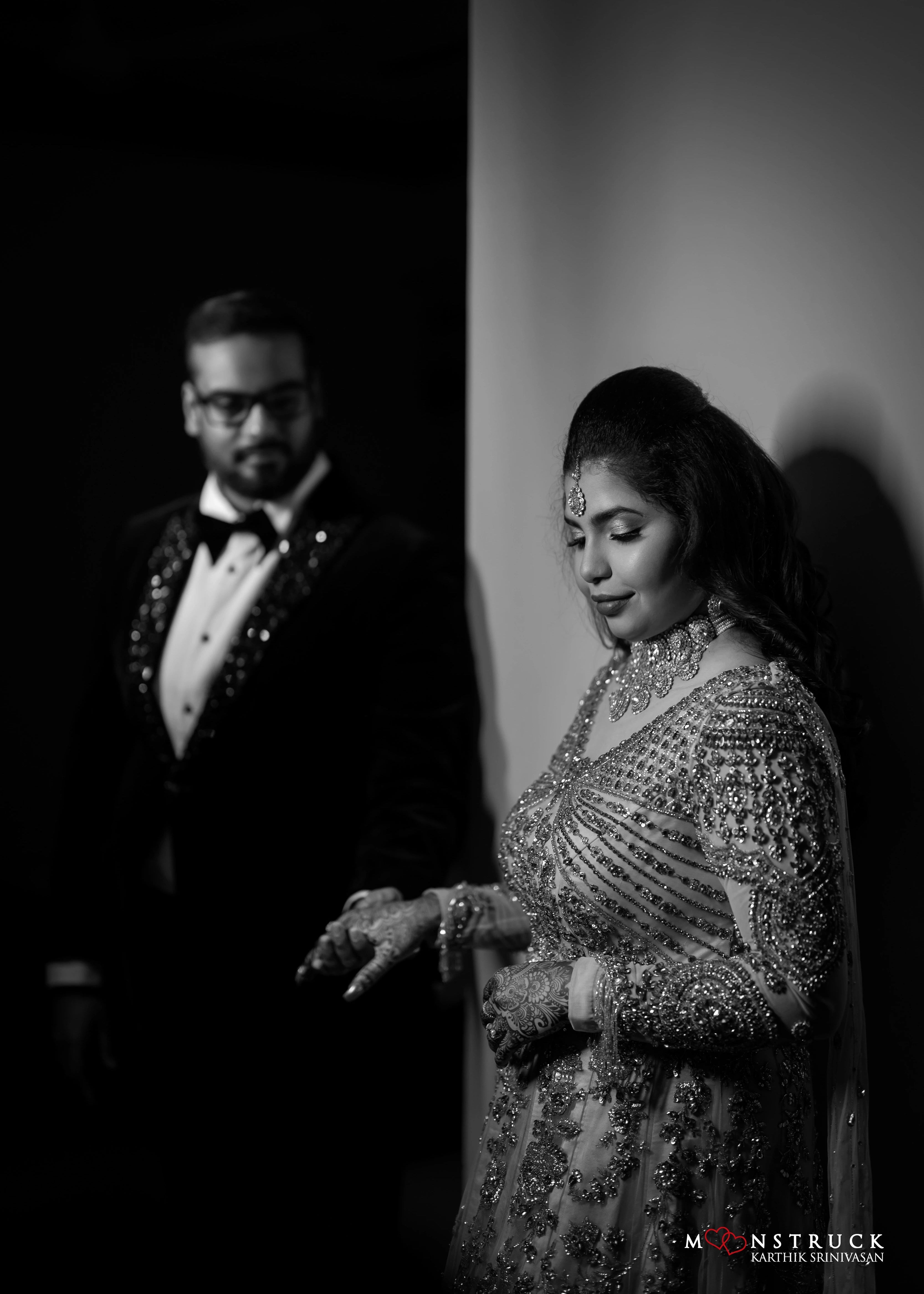 Bride hand in hand in a gold gown in tulle designed by Archana Karthick and handcrafted with rhinestones and cut dana with floral and geometric motifs.
