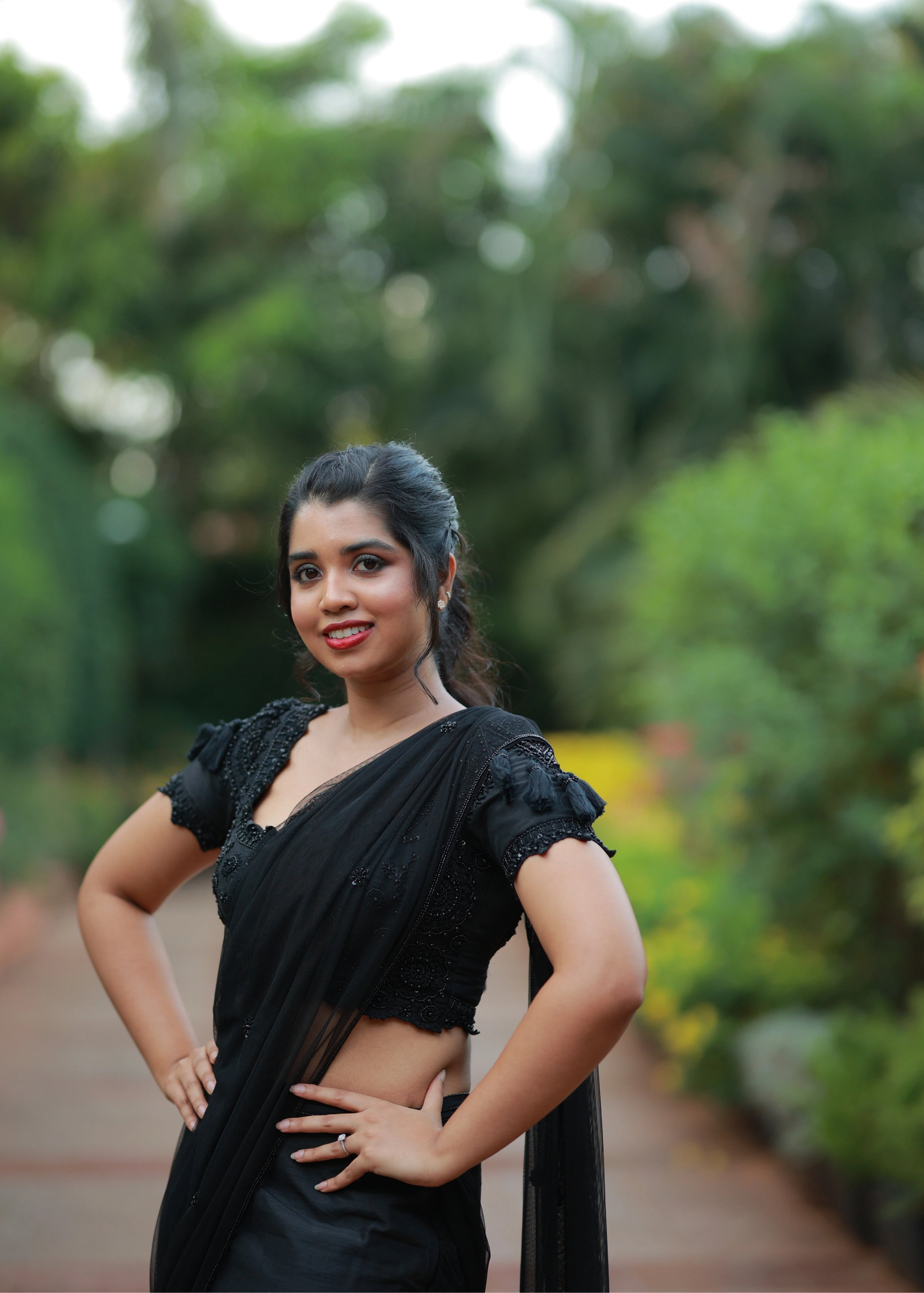 Bride in a black mermaid drape handcrafted with beads, cut dana, sequins, resham and handmade tassels to finish the look. Designed by Archana Karthick.
