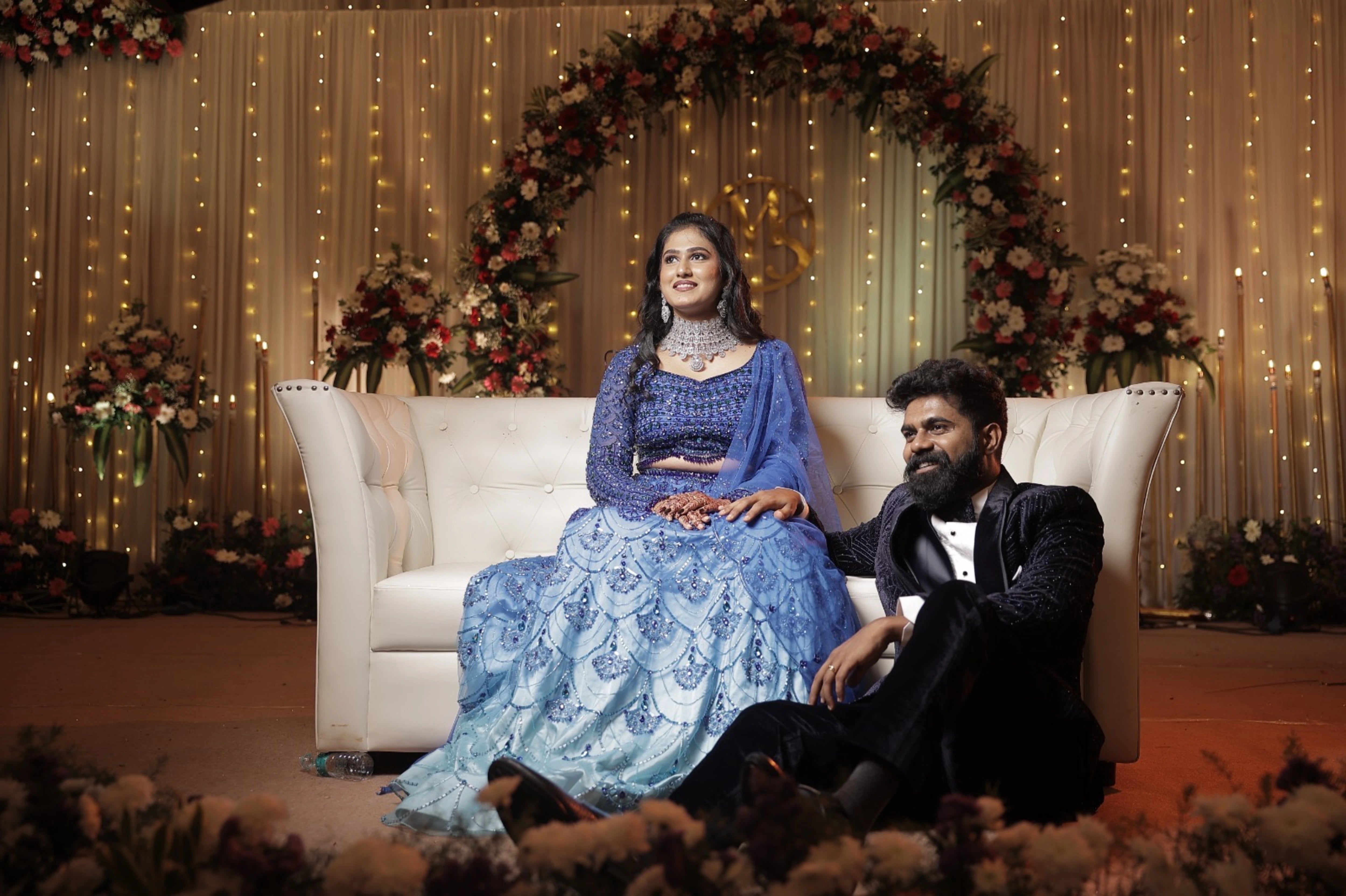 Bride Monishka in a peacock themed blue ombre tulle lehenga, handcrafted with sequins, cutdana, rhinestones and feathers by team Archana Karthick.